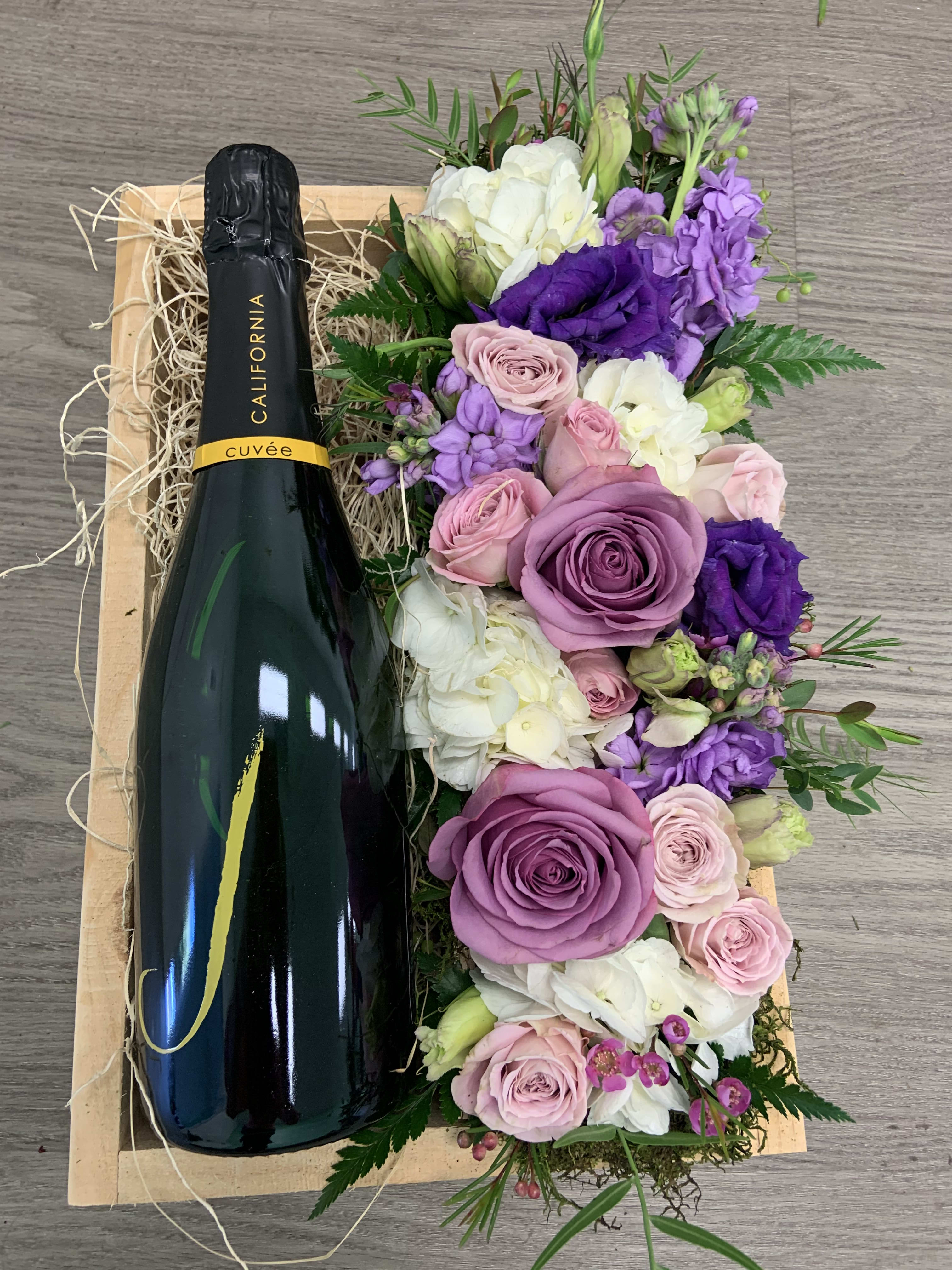 Champagne and Flowers Gift Crate - A bottle of Champagne and a lush floral design, featuring roses, hydrangea, stock and lisianthus in our hand made wooden gift crate. Available in any color upon request
