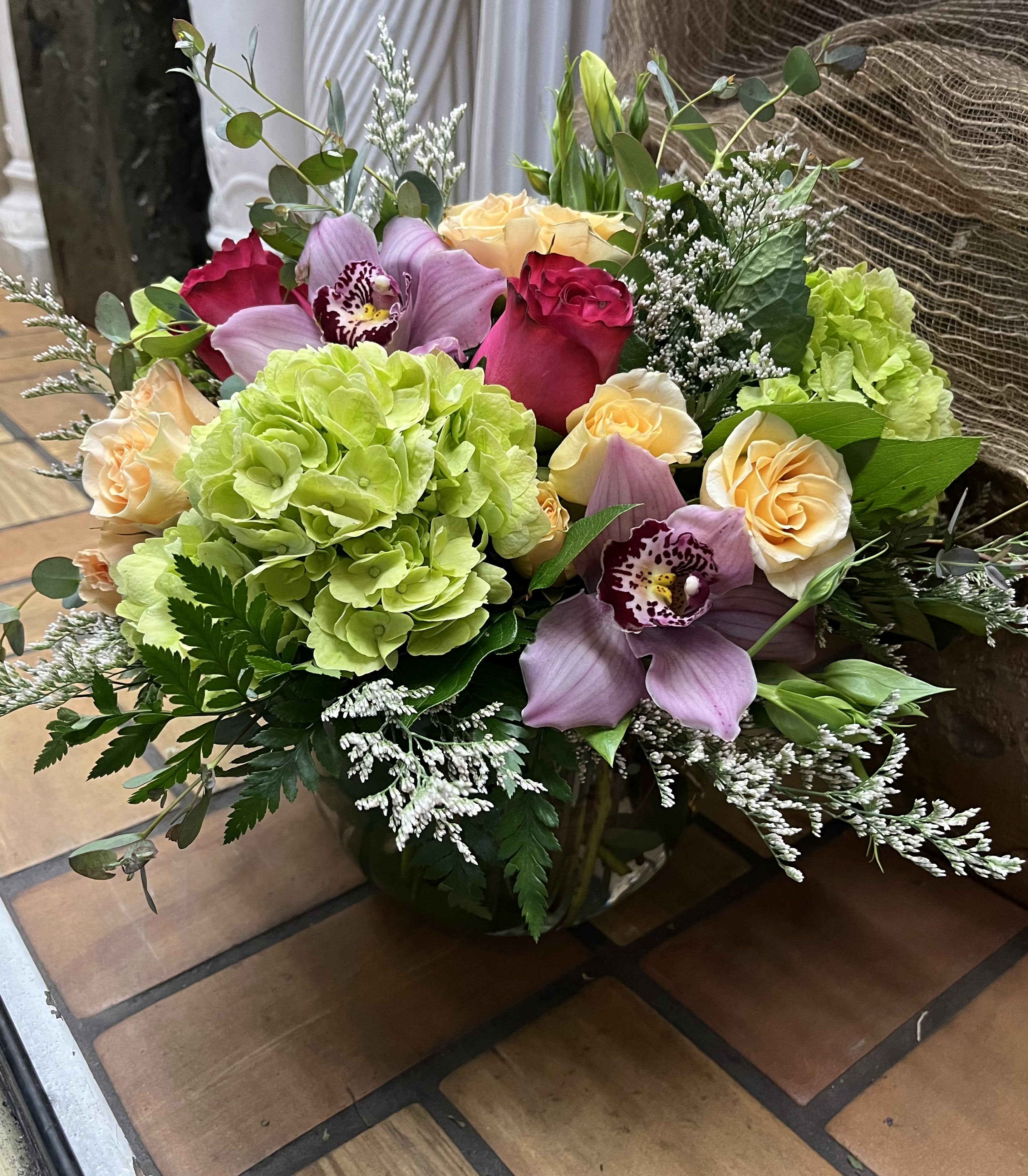Mixed bouquet with roses, hydrangea, and orchids