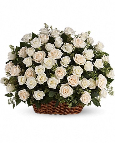 Basket of white and blush roses with greenery