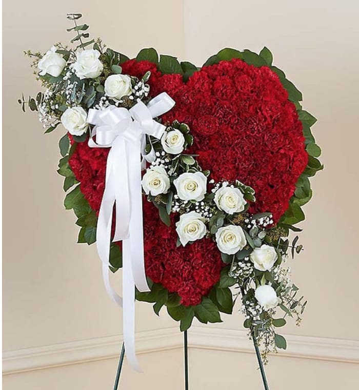 Heart-shaped red floral standing spray with white roses and ribbon