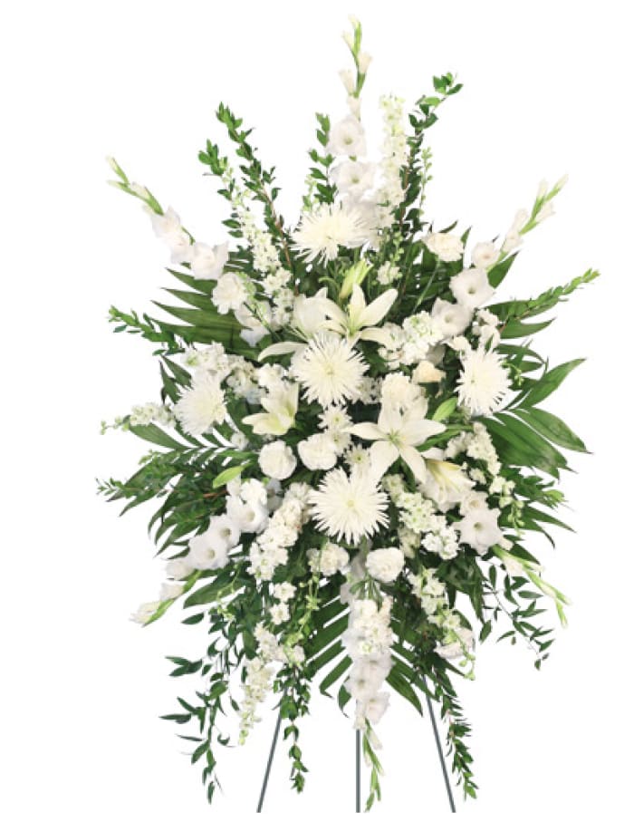 White funeral spray with lilies and chrysanthemums on a standing easel