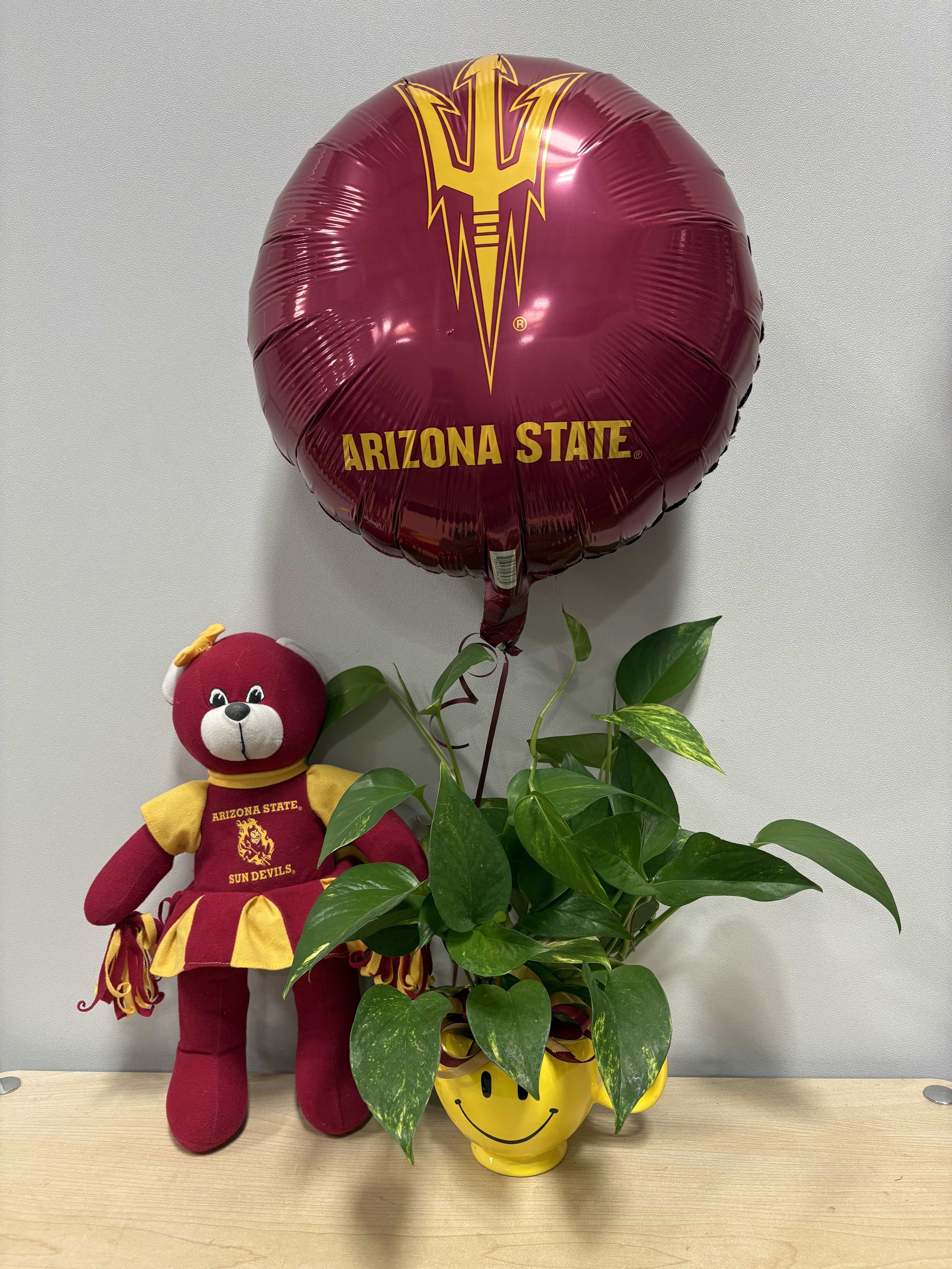 Arizona State balloon with a teddy bear and potted plant