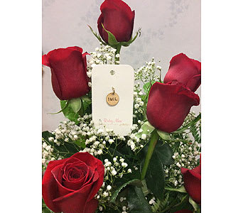 Red roses with baby's breath and a small tag