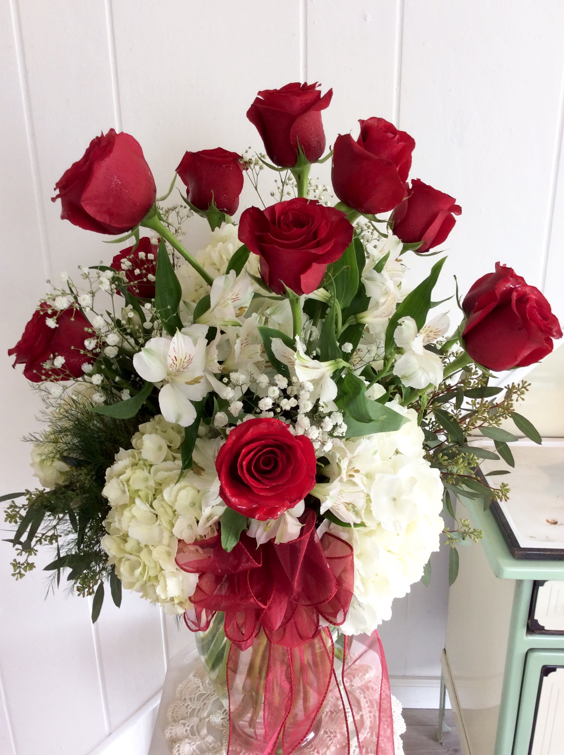 The Big One... Red Roses, Hydrangea, and Alstroemerias  - Designed to Impress!  Delight their senses and make a long-lasting impression with this full vase of Fluffy Domed White Hydrangeas, a Dozen beautiful Premium Red Roses complemented with an array of Alstroemerias, Baby's Breath topped off with a nice assortment of greens, sheer ribbon bow, and your message card.  So pretty...  Vase style may vary.  If you prefer roses of different colors, please get in touch with me directly at 401-828-0701 for availability.  Thanks,  Cheryl      ***On occasion, filler flowers may vary due to local availability.