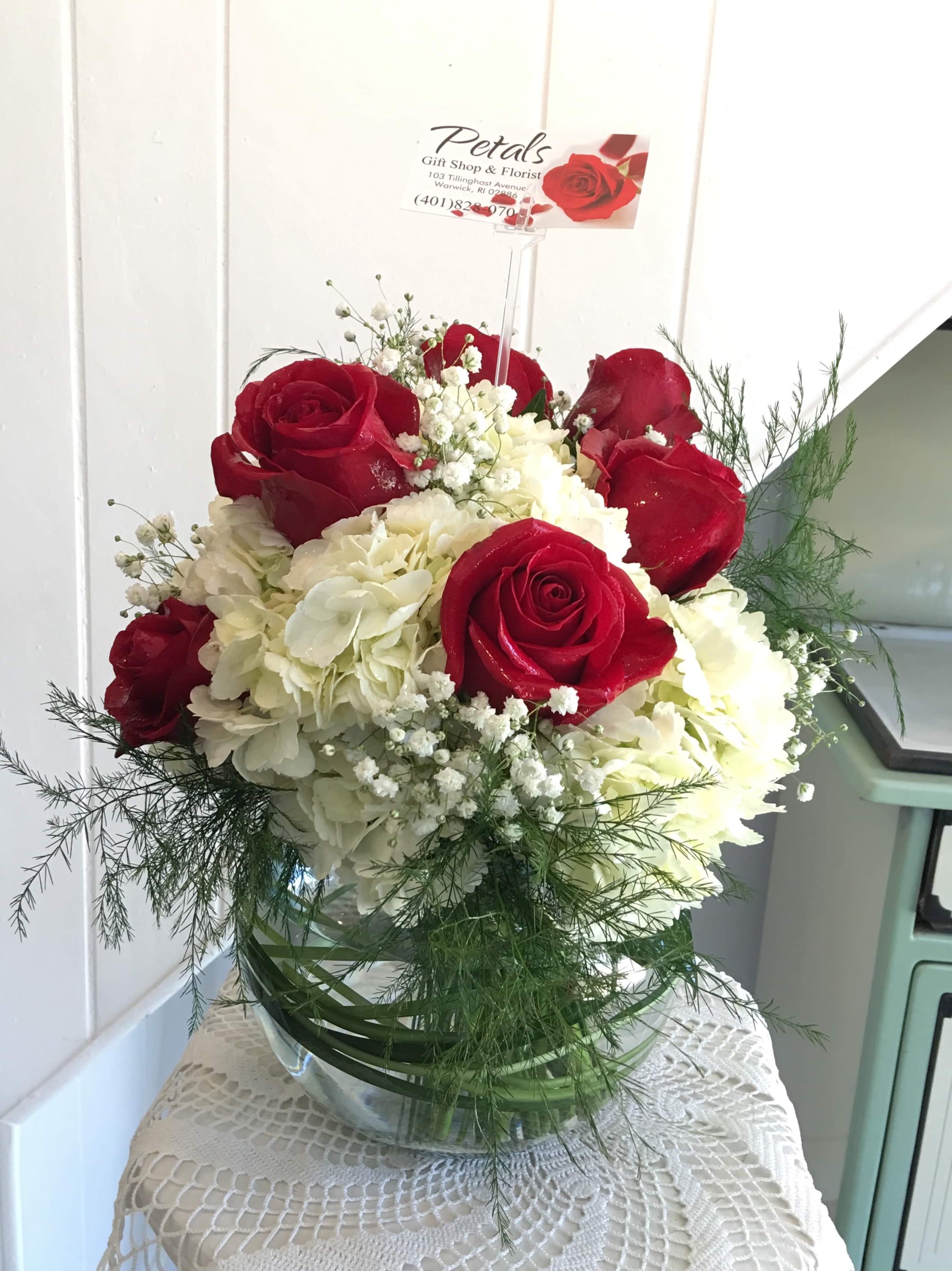 Red Roses &amp; White Hydrangea Bubble Bowl by Petals - This impressive bubble bowl is filled with fluffy mounds of White Hydrangea surrounded by beautiful premium Red Roses, Baby's Breath, and Tree Fern.  This design is sure to brighten up anyone's day!   Winter greens are used beginning in December. * Please call me at 401-828-0701 if you prefer roses of different colors.   Thank You,  Cheryl