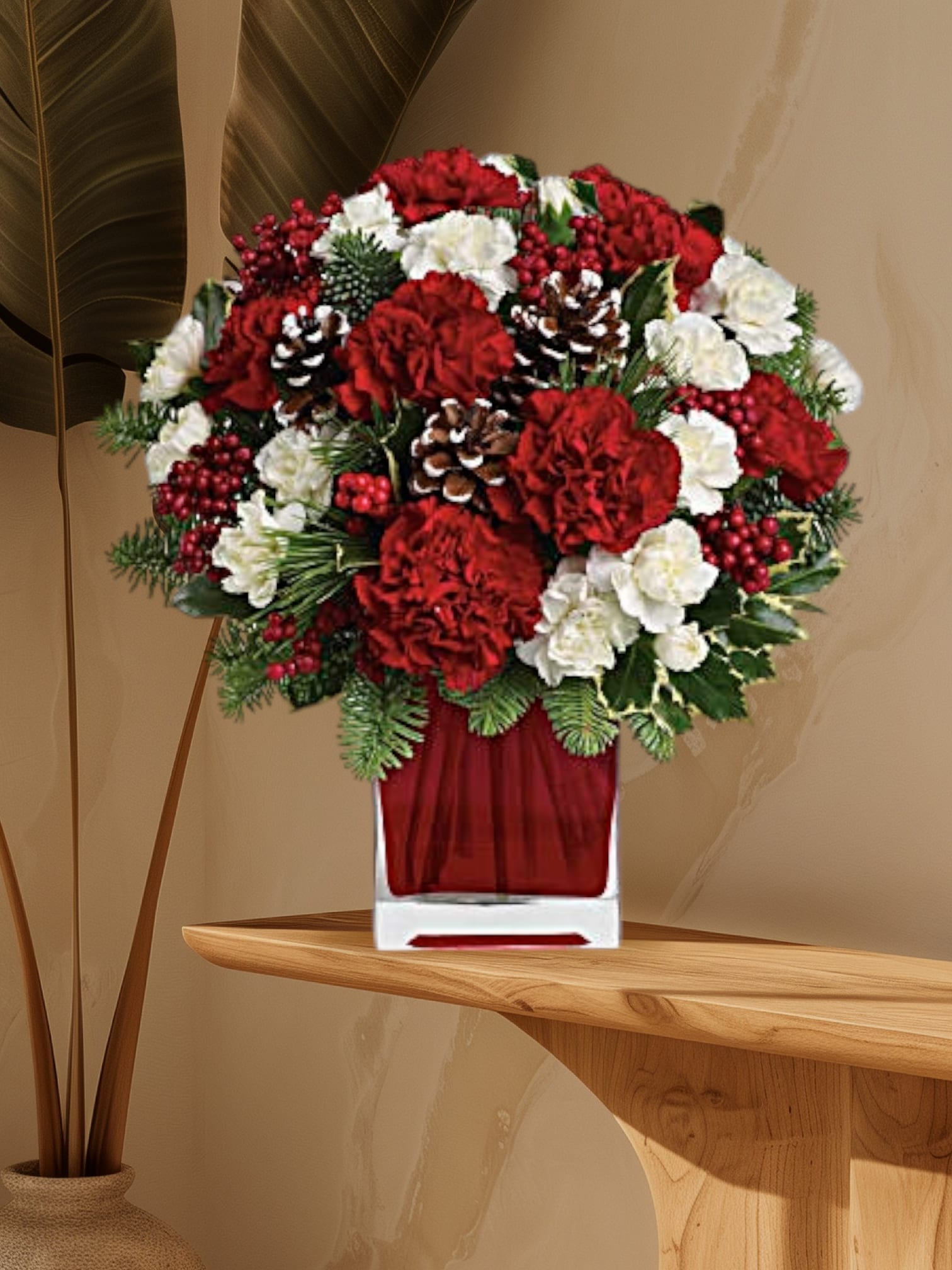 Red and white floral arrangement in a clear square vase