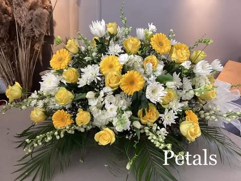Yellow roses and white daisies arranged in a large bouquet