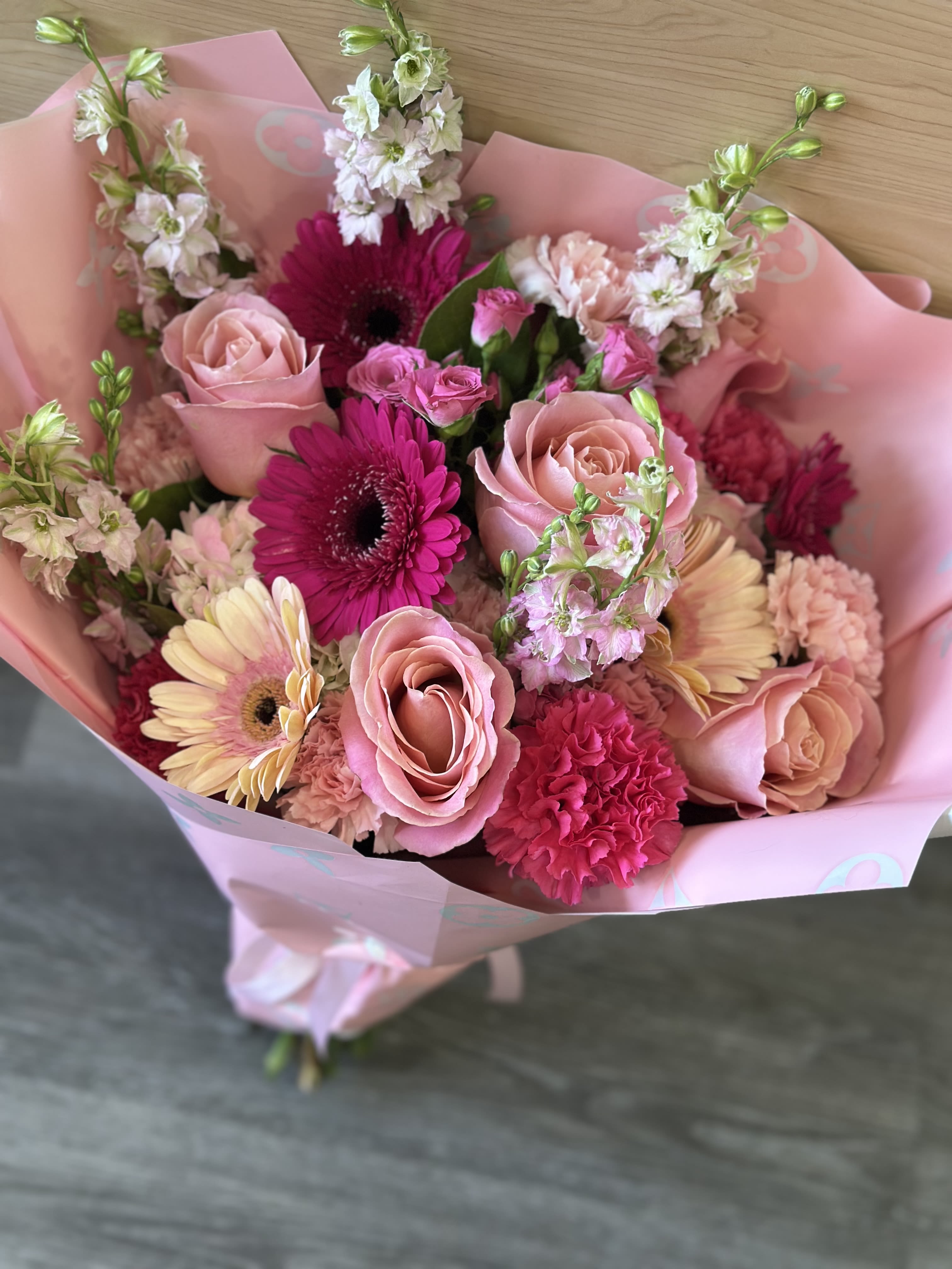 Designers choice of Pink's - Our professional florists have put together a wrap bouquet of flowers that stands out above the rest to show her how much you care on a day that’s all about her 