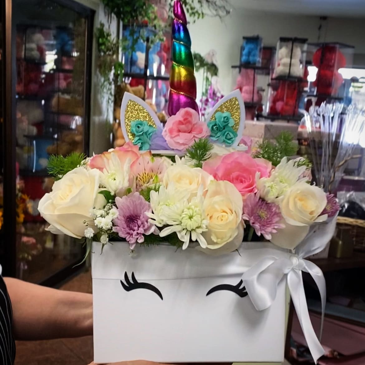 Unicorn-themed flower box with pastel roses and daisies