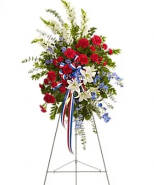 Standing floral spray with red, white, and blue flowers on an easel