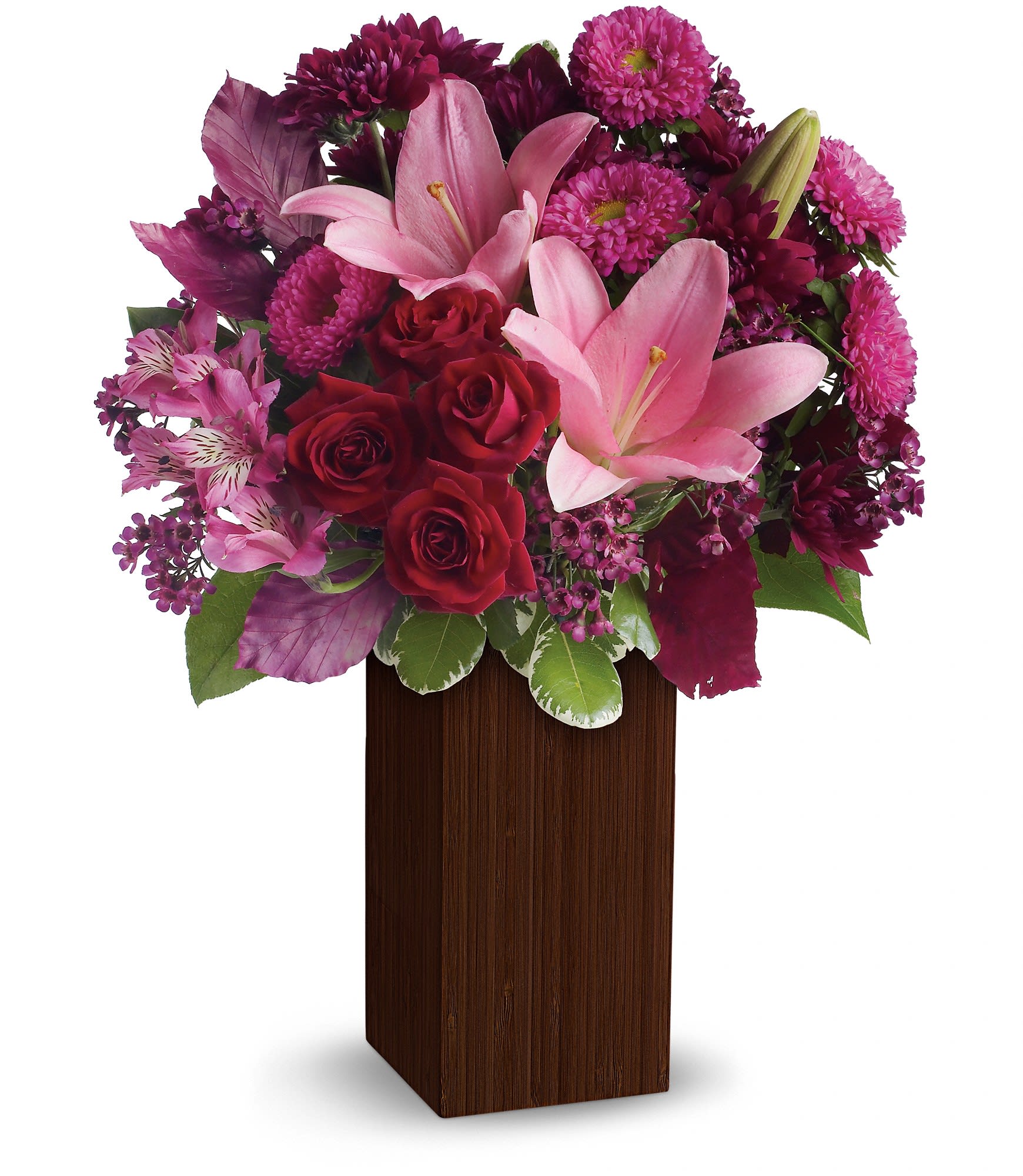 Pink lilies and red roses in a tall wooden vase