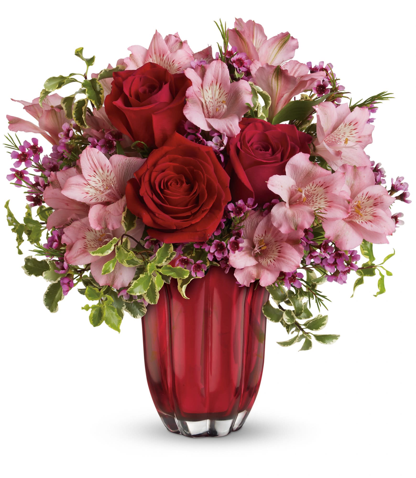 Red roses and pink lilies arranged in a red glass vase