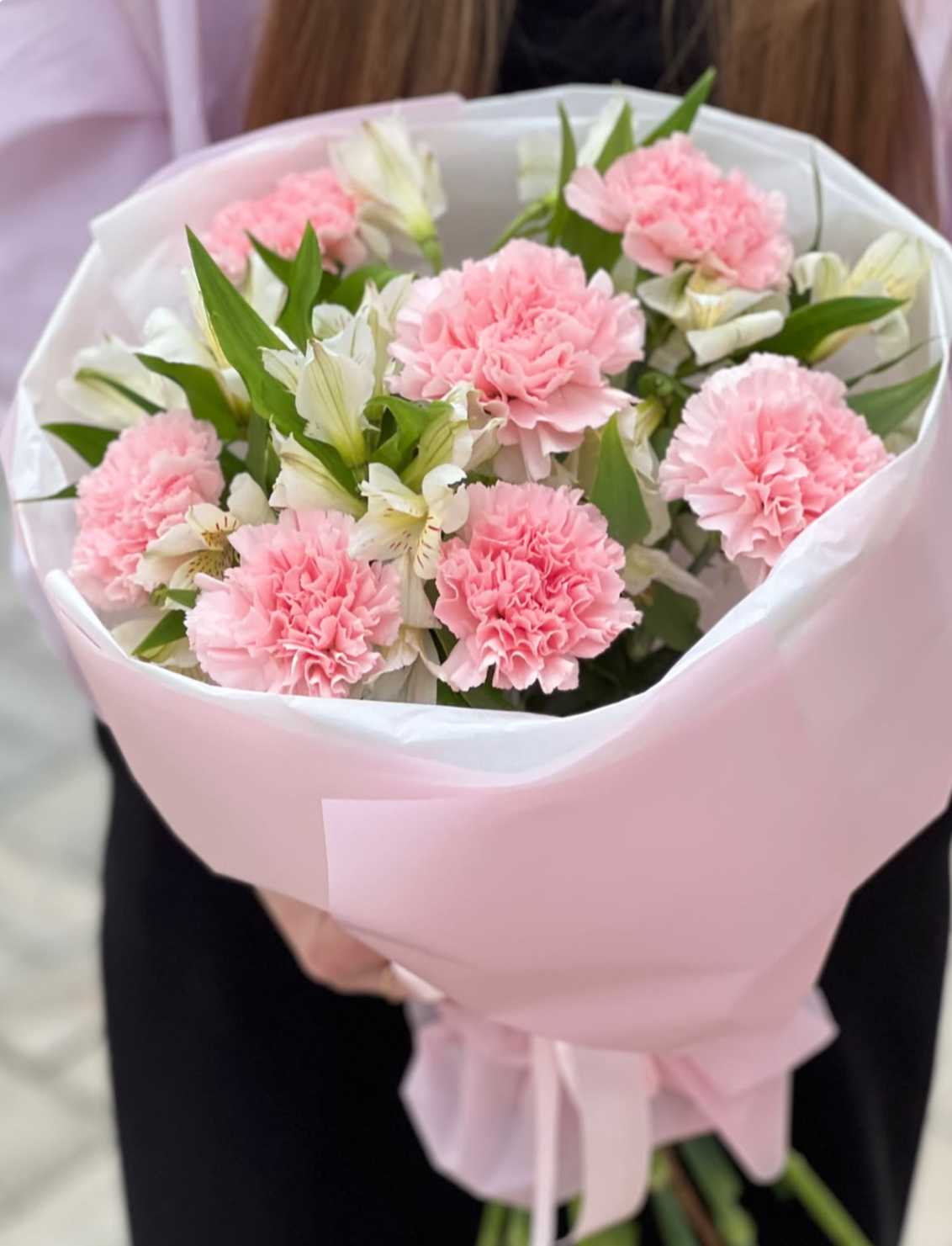 Pink carnations and white alstroemeria in pink wrapping