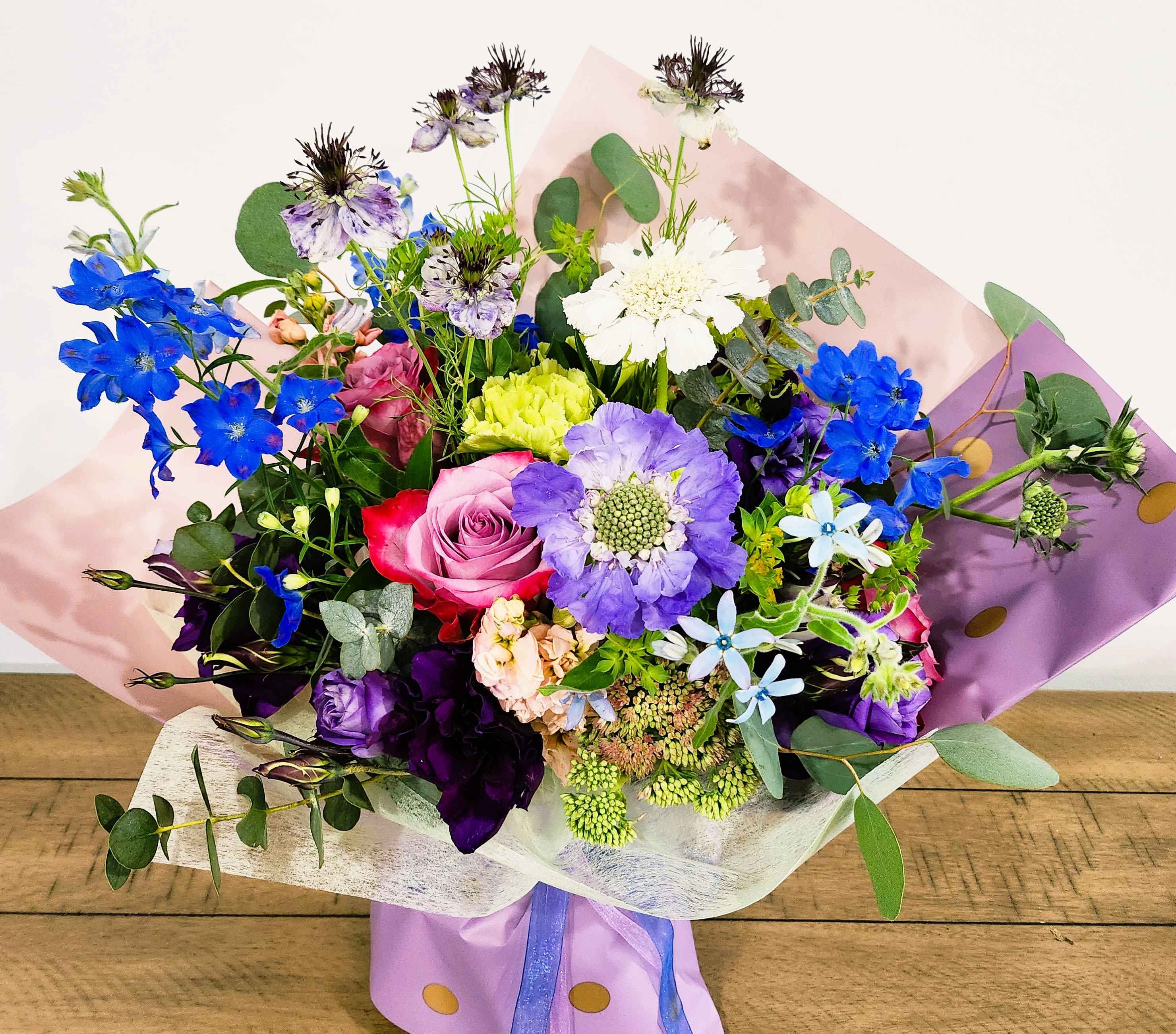 Bouquet of mixed flowers in purple and pink wrapping