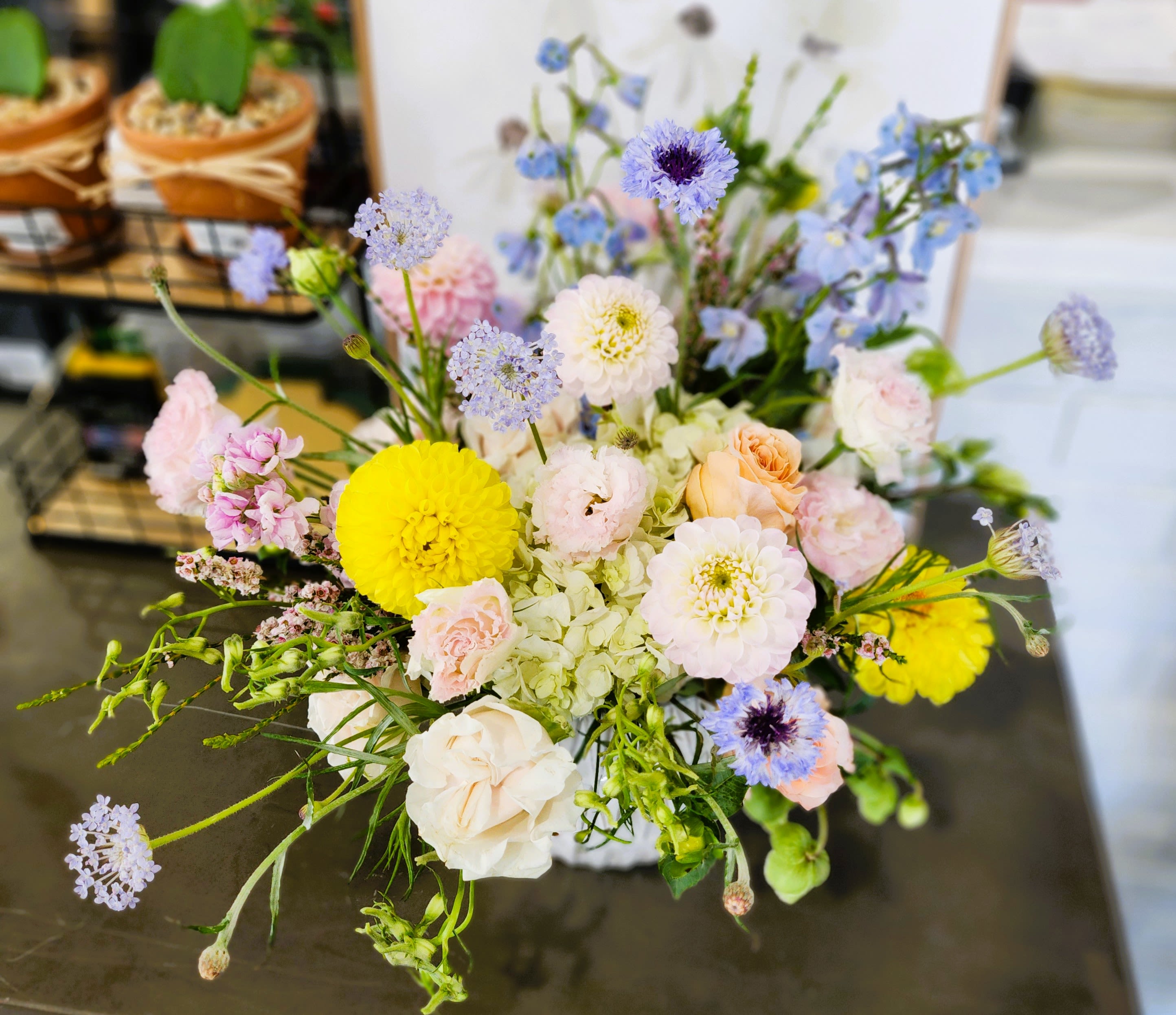 Mixed pastel bouquet with yellow and white blooms in a vase