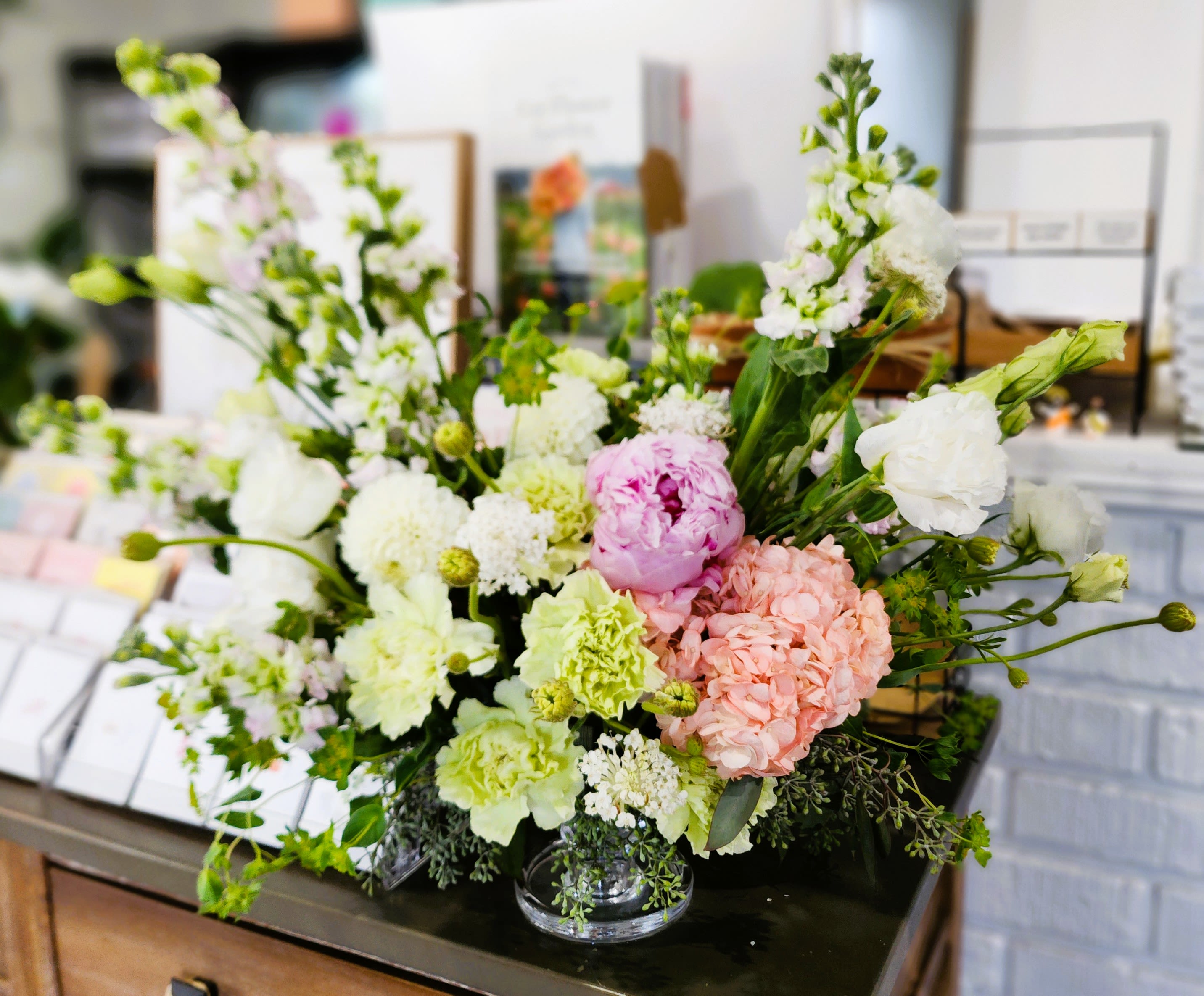 Mixed pastel flower arrangement in a clear glass vase