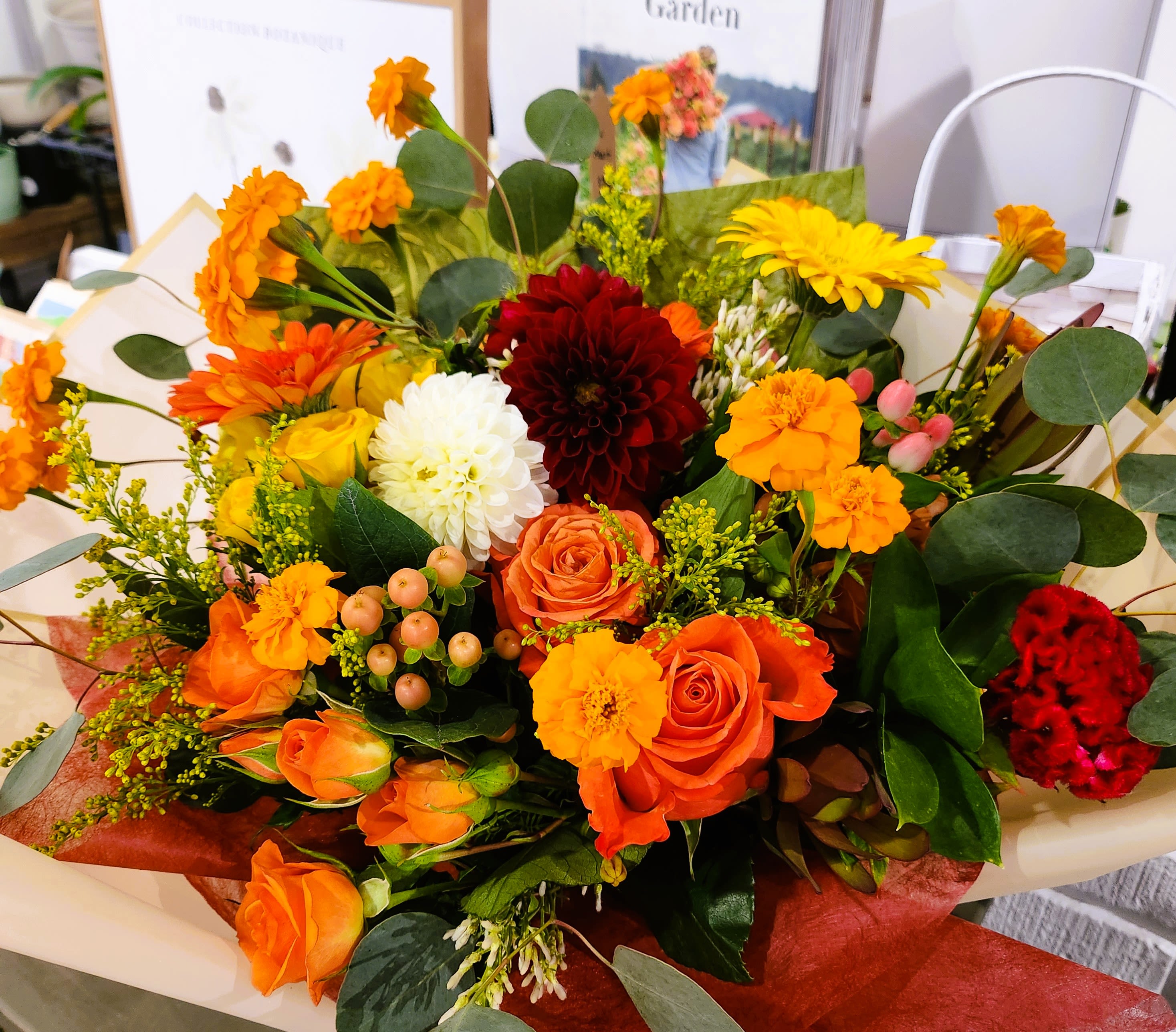 Mixed bouquet of orange, yellow, white, and red flowers