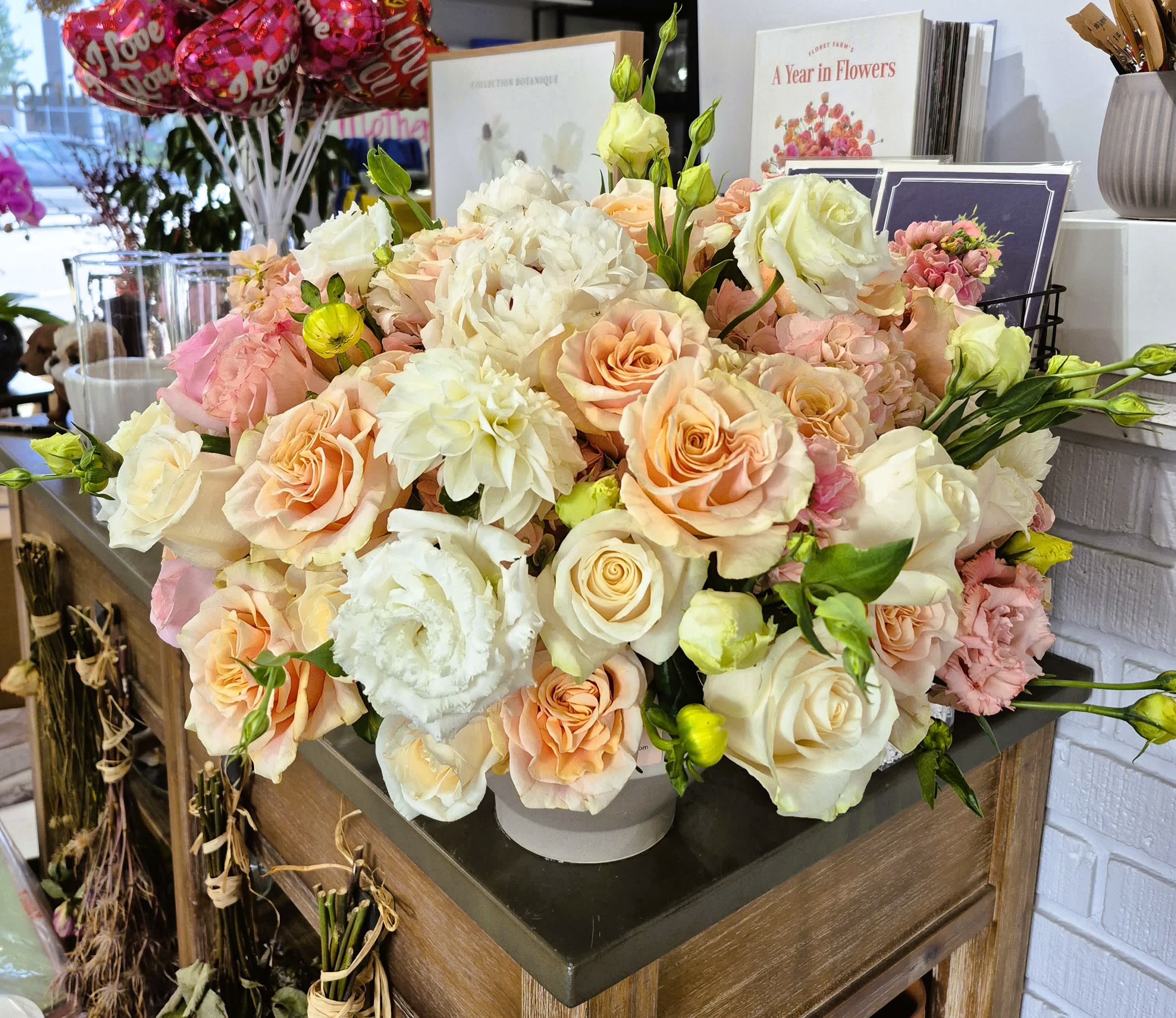 Large bouquet of peach, white, and pink roses with white lisianthus
