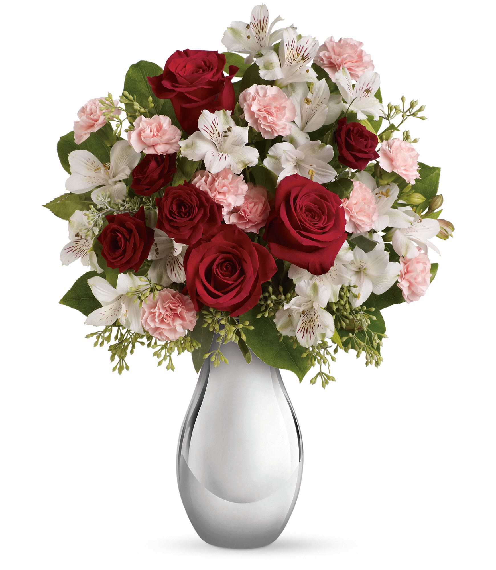 Red roses and pink carnations with white alstroemeria in a glass vase