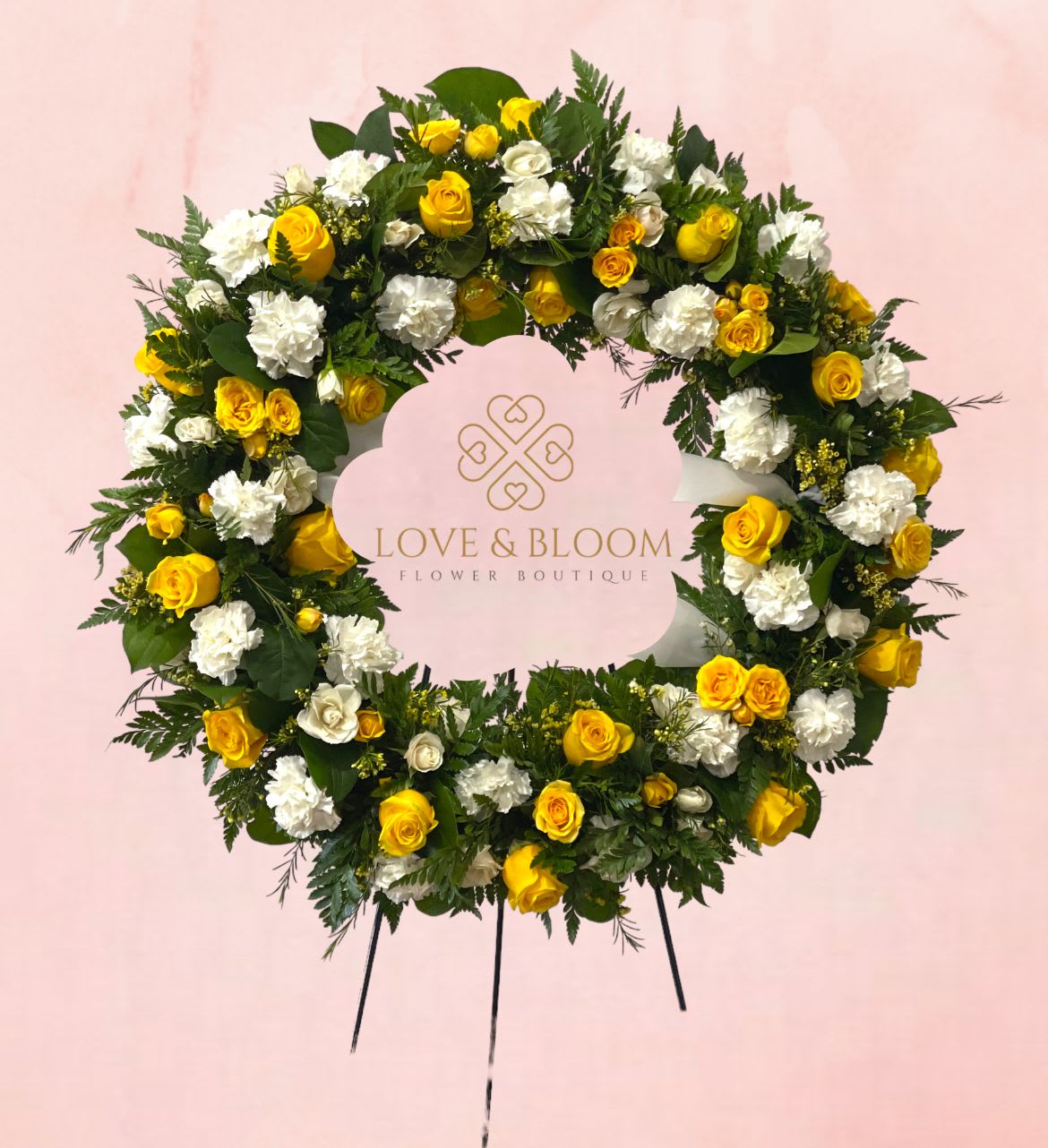 Yellow and white floral wreath on a pink background