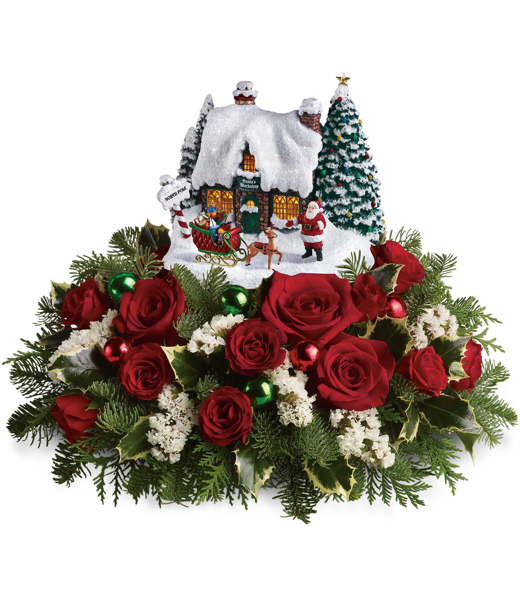 Red rose arrangement with a snowy Christmas village centerpiece