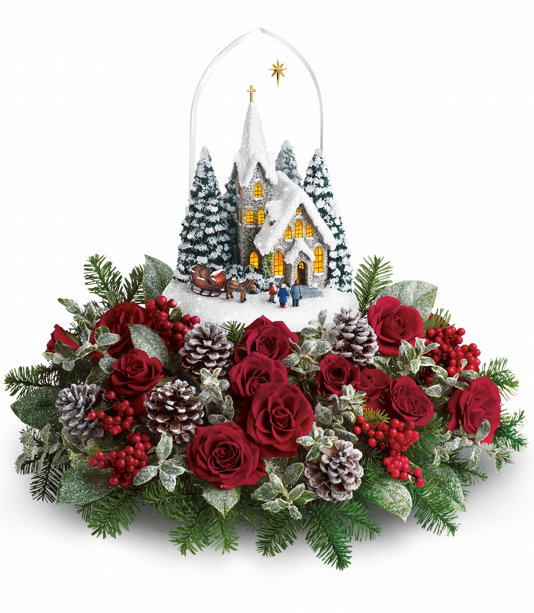 Christmas floral arrangement with red roses, pinecones, and a snowy church ornament