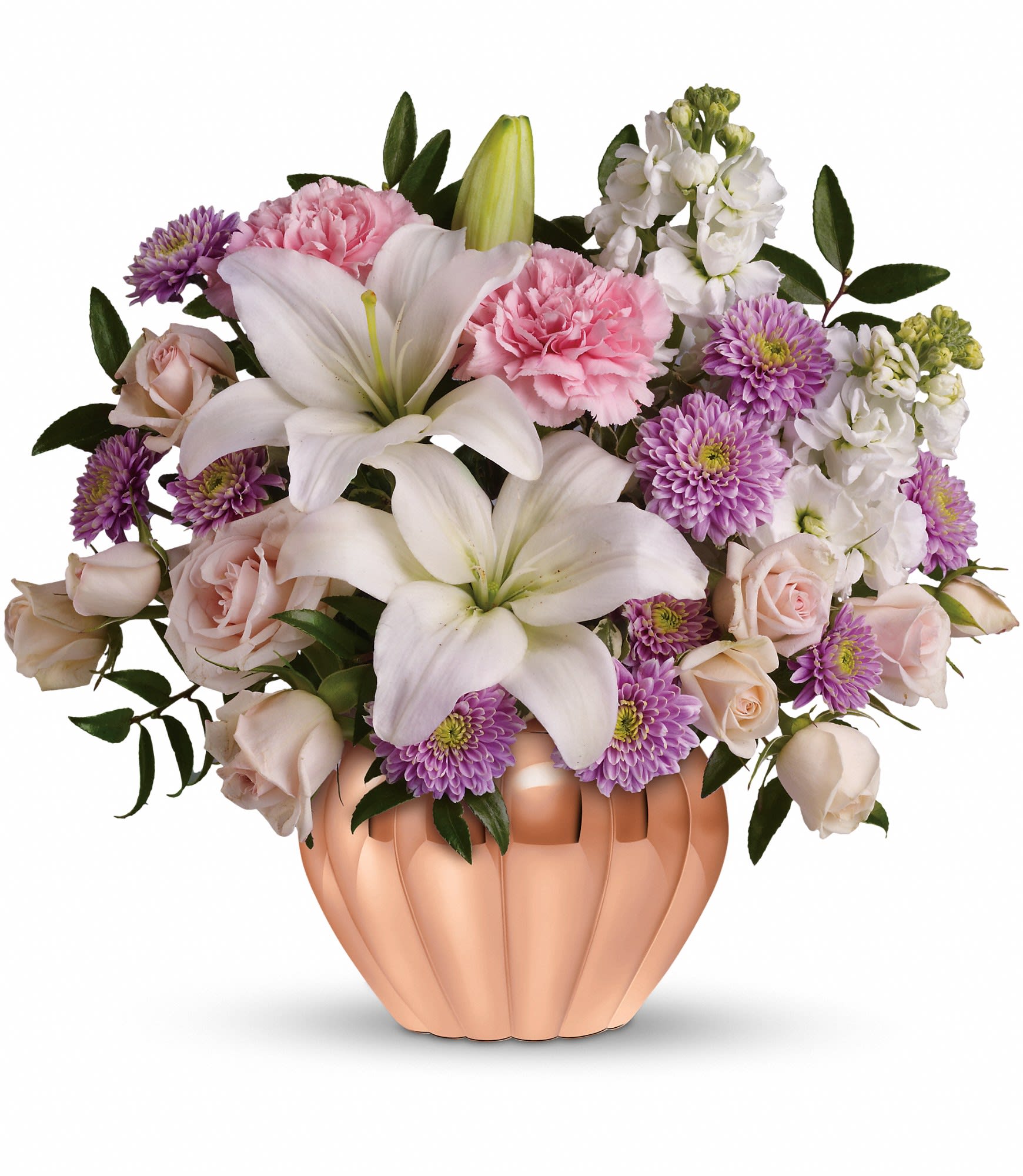 Pink and white bouquet with lilies, roses, and purple flowers in a peach vase