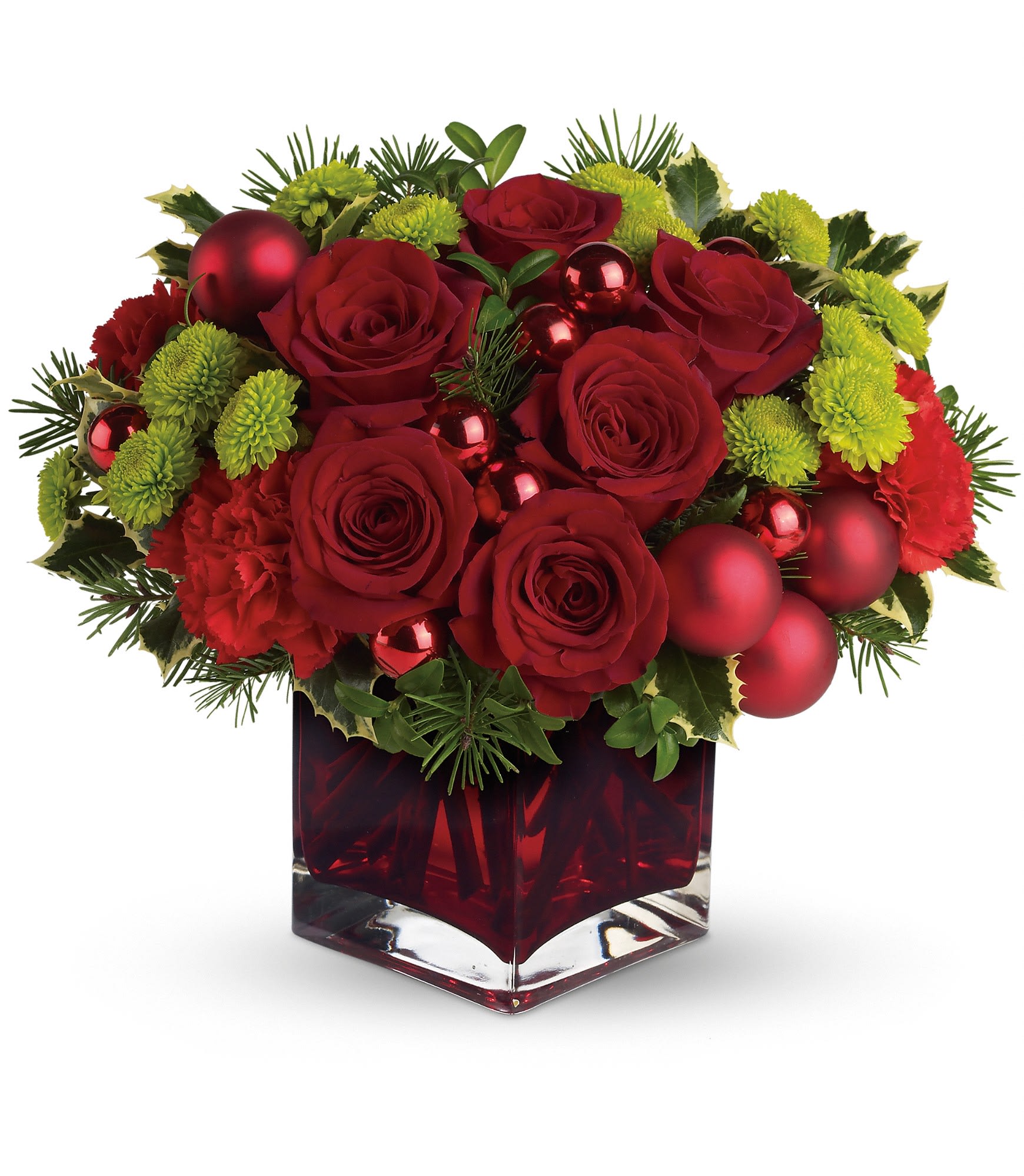 Red roses and green mums arranged in a red glass vase with ornaments