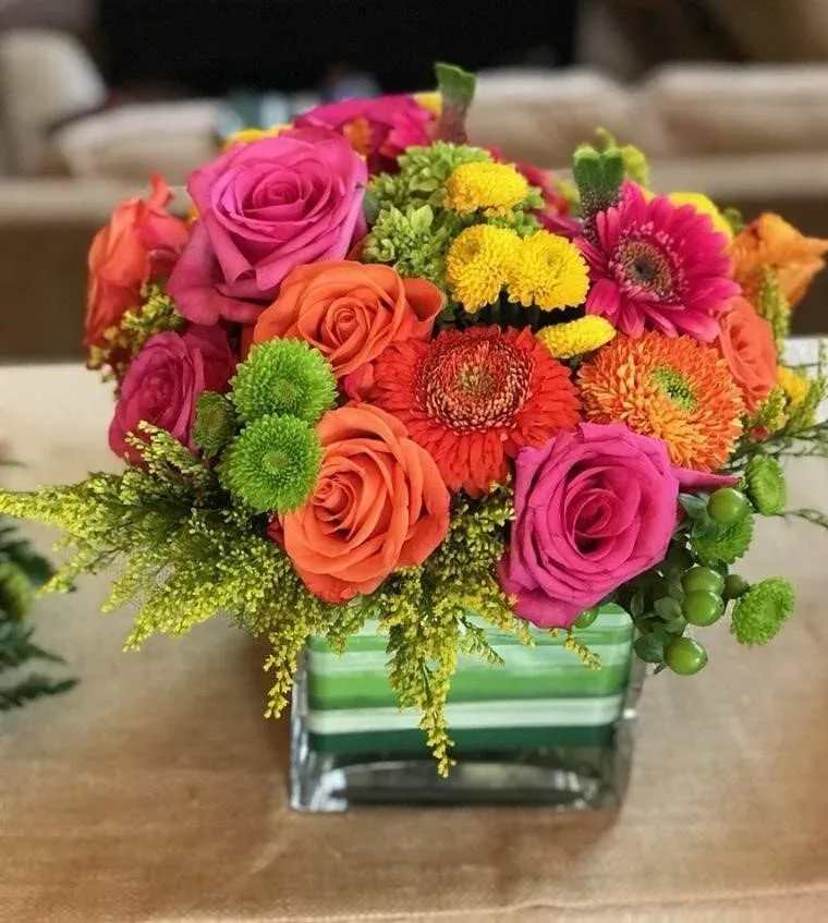 Bright mixed bouquet in a striped glass vase
