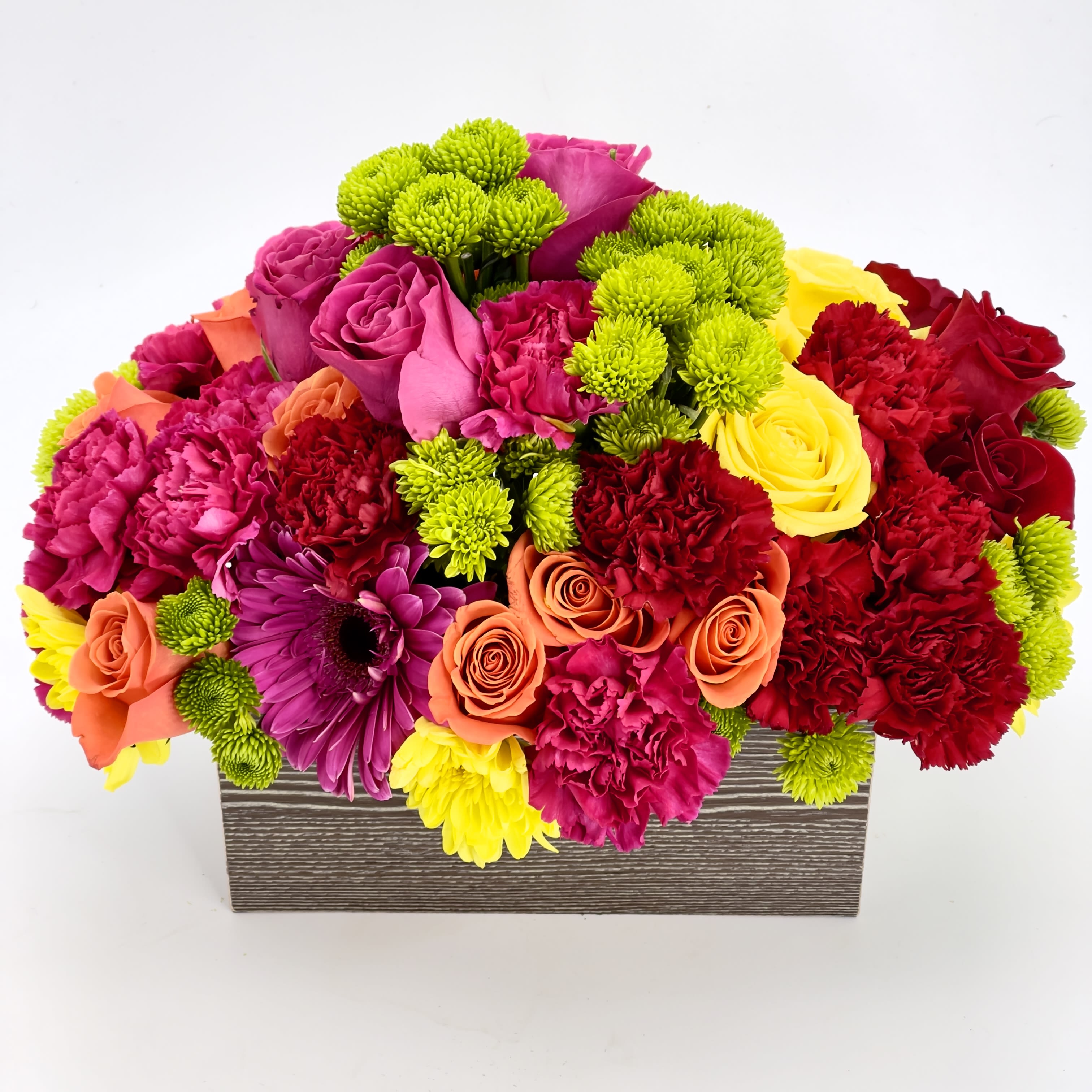 Dreamland Bouquet  - This beautiful multi color bouquet, consisting of Roses, Carnations, Gerber Daisy, button Pom Pom’s in a rectangular wooden container. 
