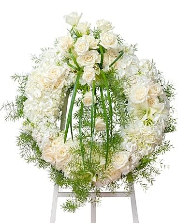 Elegant Wreath - A combination of cream and white blooms in this wreath makes a beautiful elegant setting. 