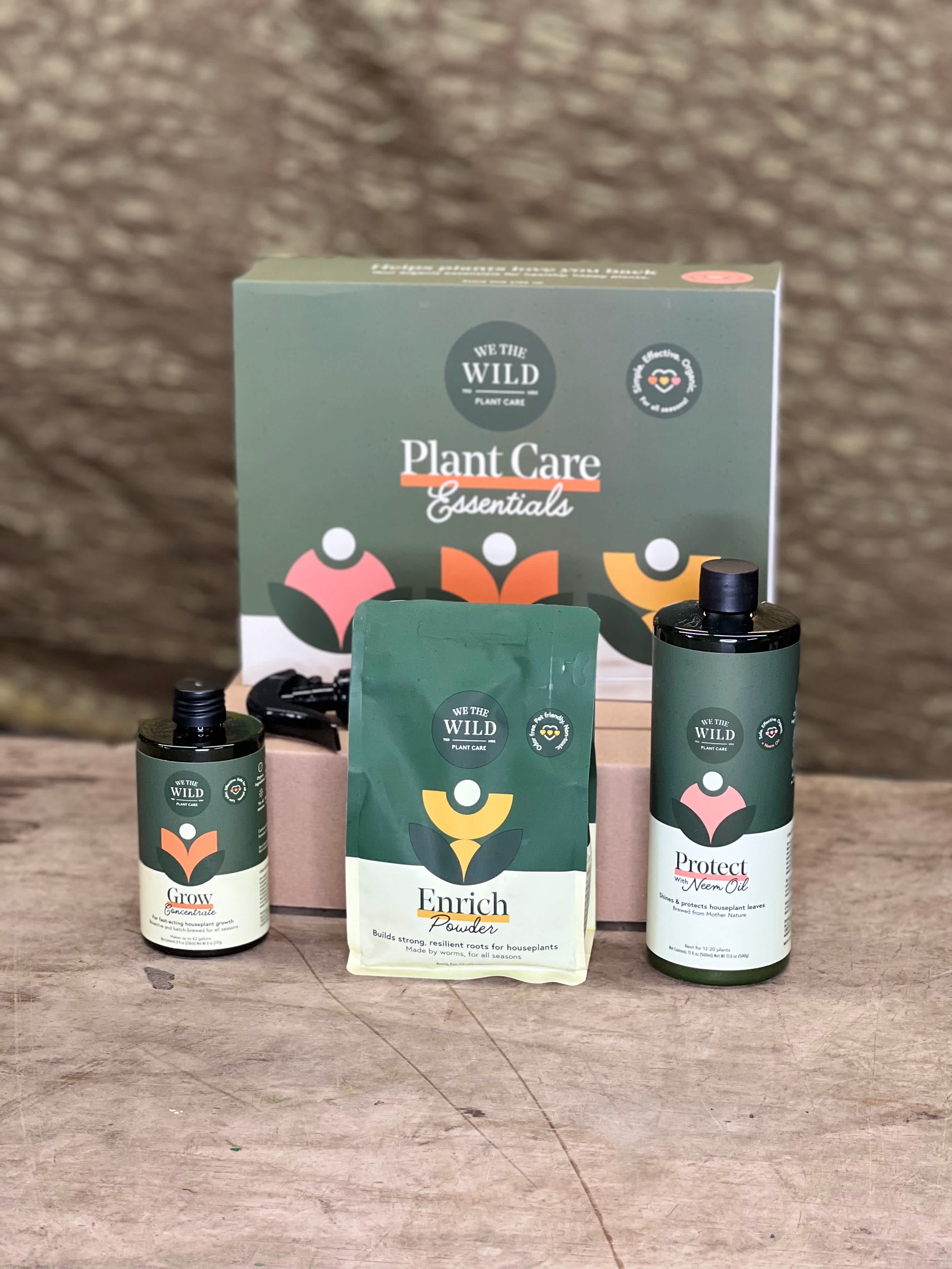 Plant care gift set with three bottles and a pouch in front of a box