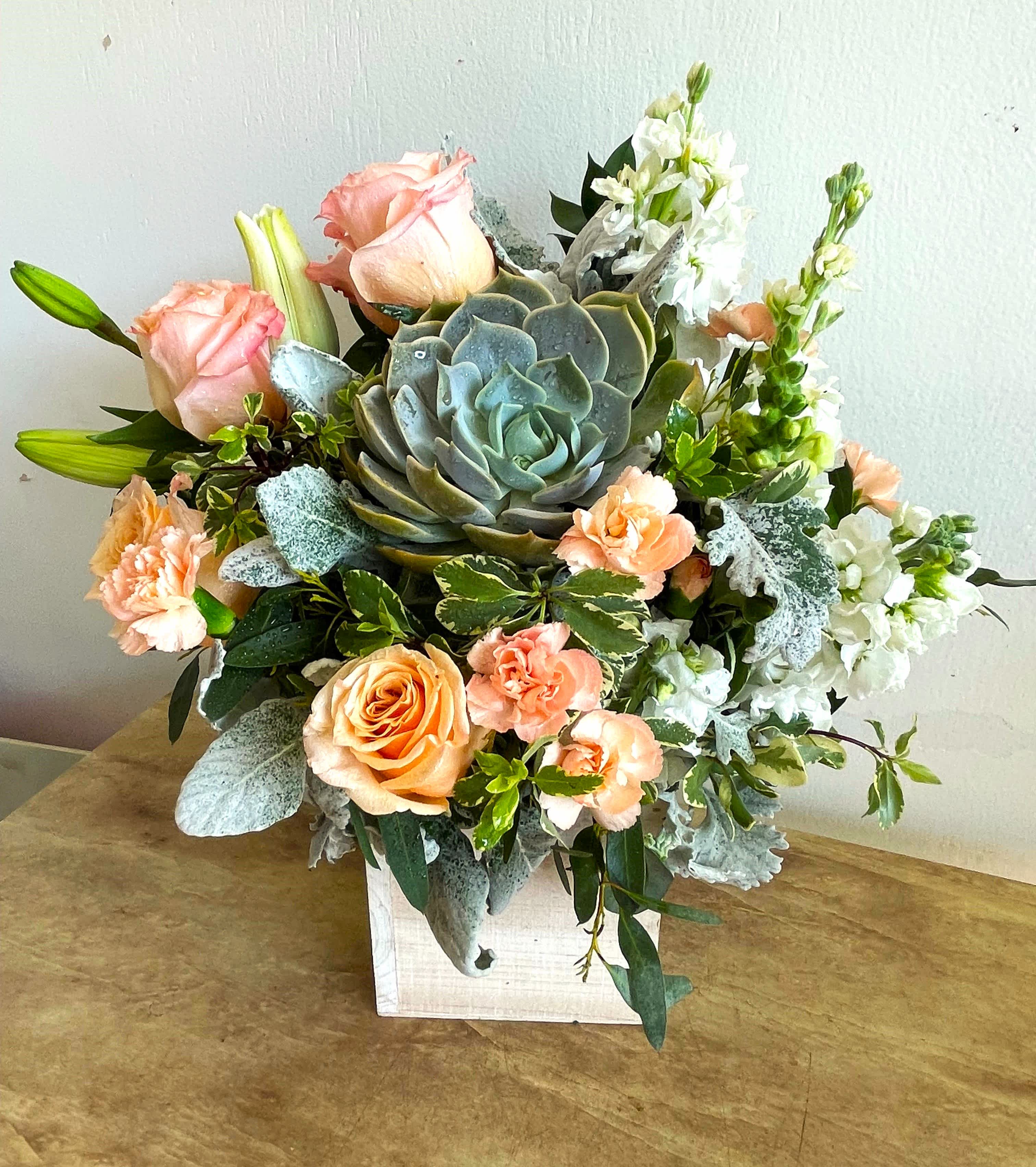 Desert Sunrise Bouquet  - Peaceful yet energizing, this unforgettable arrangement of desert-hued blooms and succulents in a sleek wood cube is a chic gift on any special occasion.  Roses and tiger lilies with other beautiful flowers make this a fantastic item.