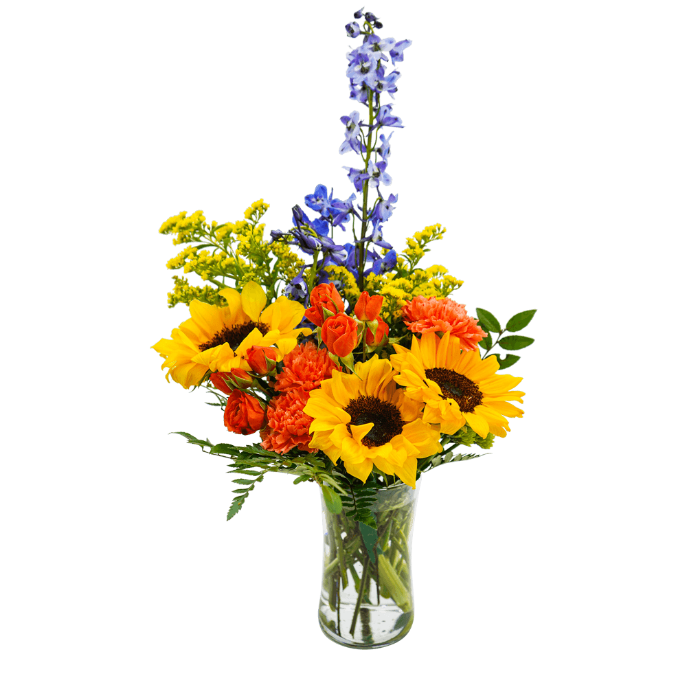Bouquet of sunflowers, orange carnations, and blue delphinium in a clear glass vase