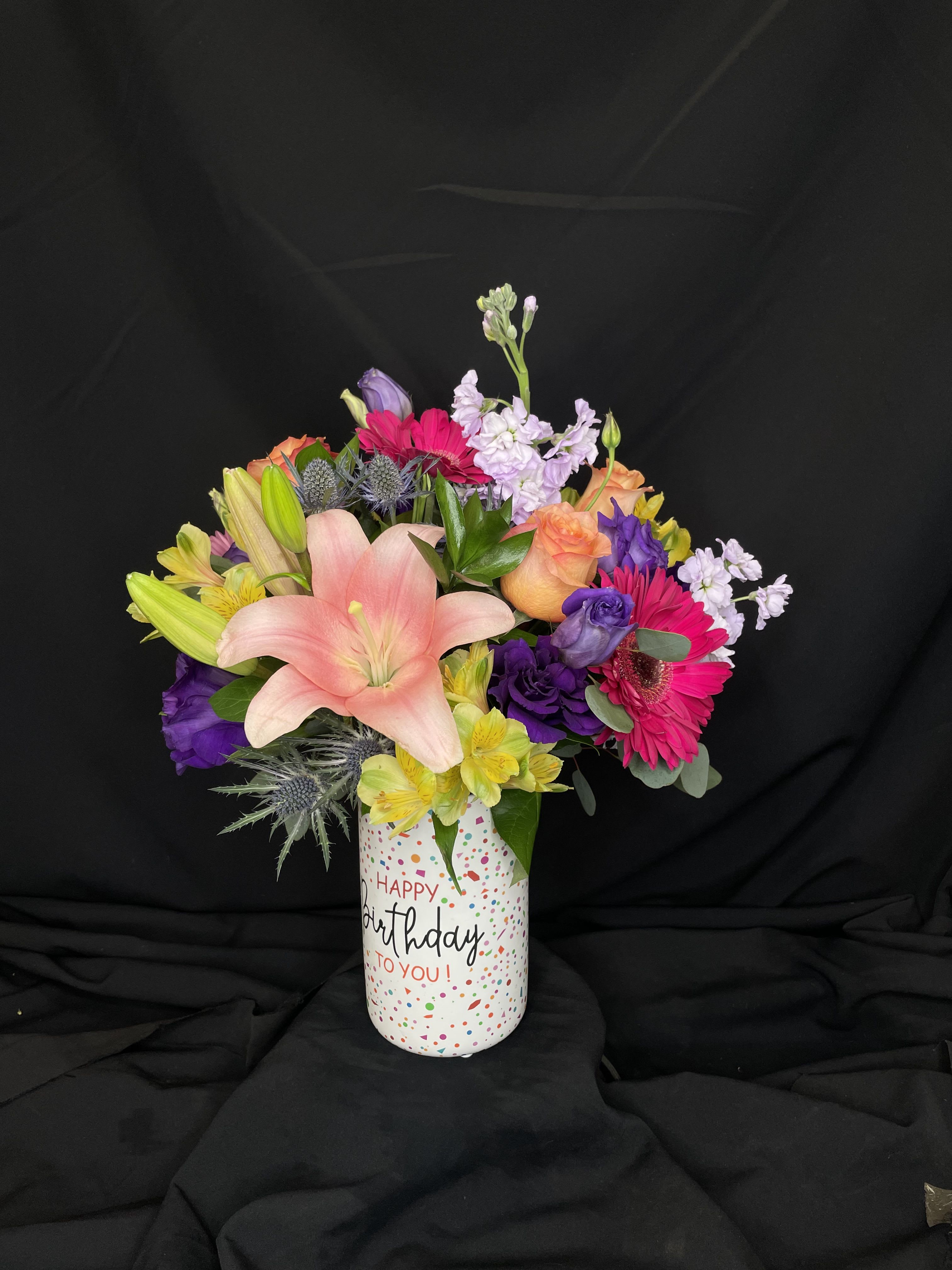 Mixed bouquet in a birthday vase with pink lily and bright gerberas
