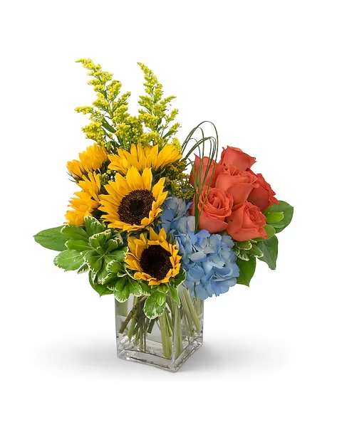 Fun in the Sun - Swimsuits, snow cones and plenty of sunscreen. All things you need for a day of Fun in the Sun. Roses, sunflowers, hydrangea and loops of lily grass make a splash in this cheery bouquet. Why not bring a little of that inside? Call us and we will be happy to hand deliver your floral gift. 