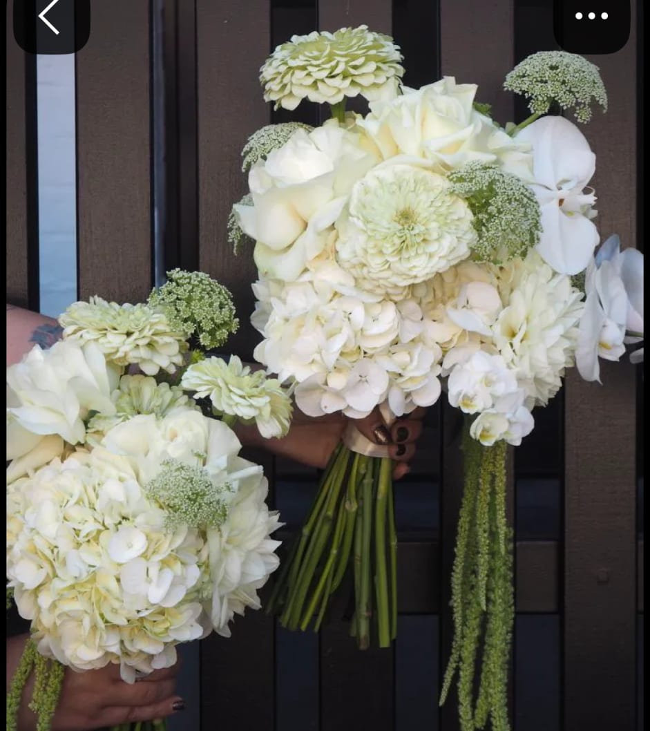 White wedding bouquets with roses, hydrangeas, and orchids