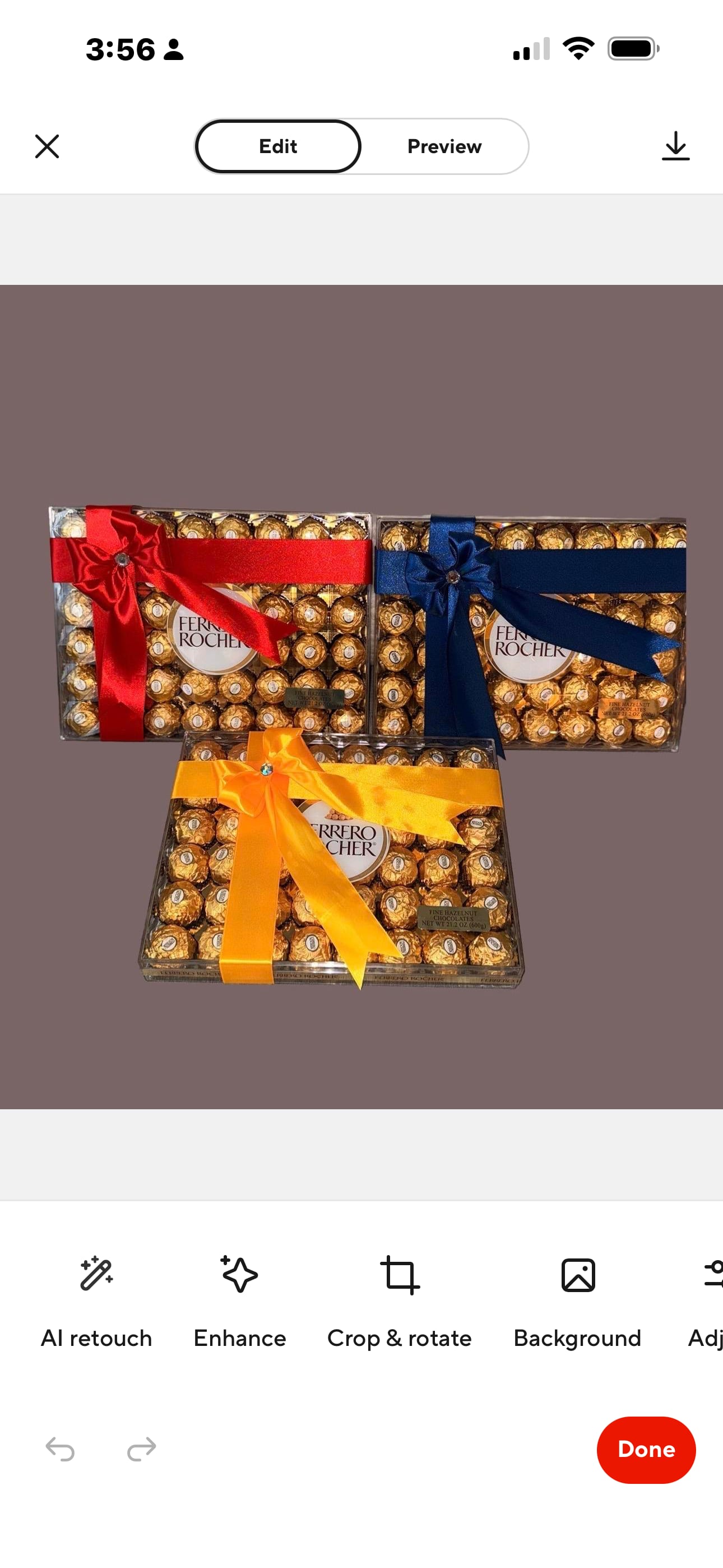 Three Ferrero Rocher chocolate gift boxes tied with red, blue, and yellow ribbons