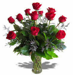 Red roses arranged in a clear glass vase