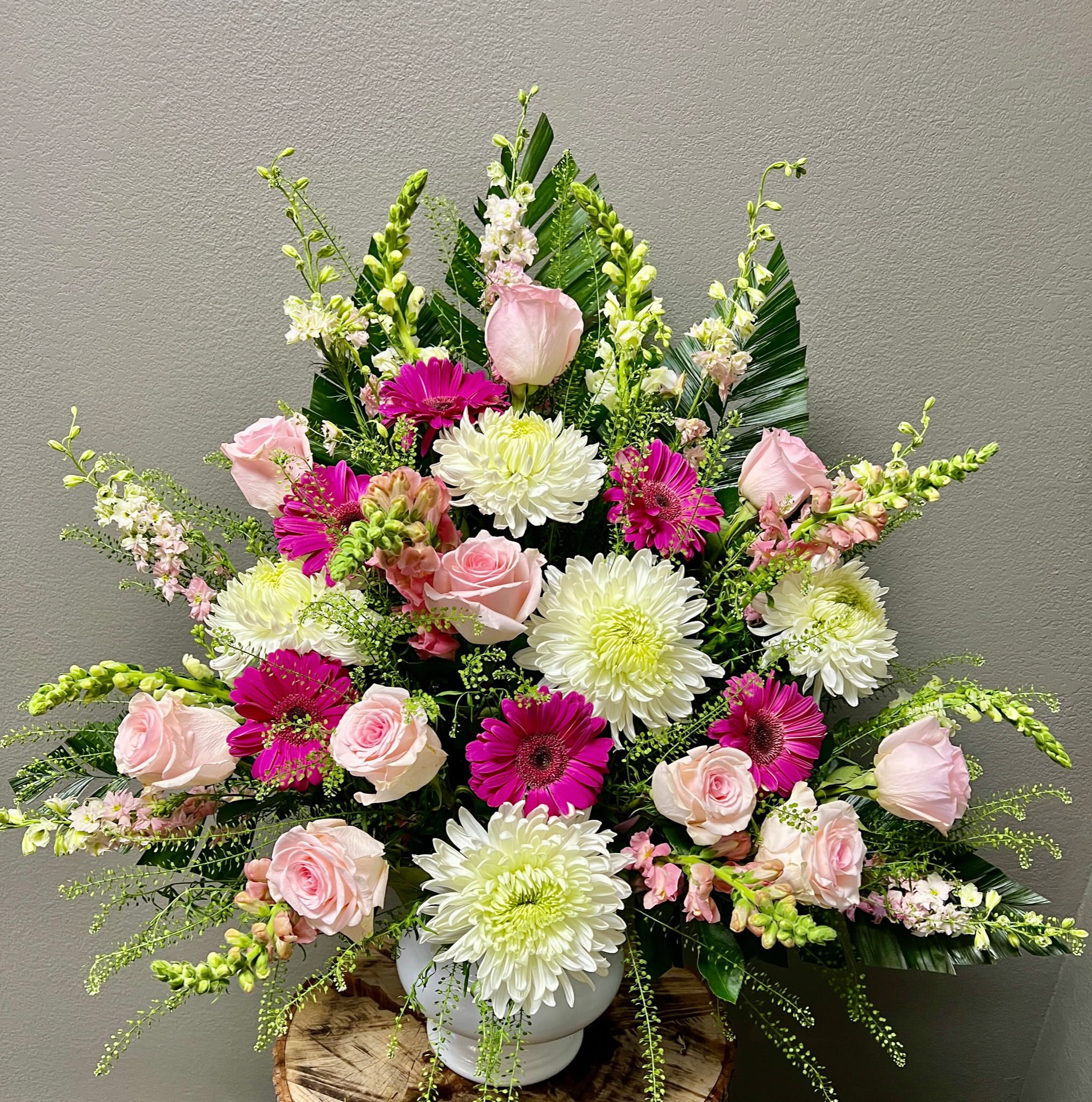 Pink roses and white chrysanthemums in a white vase