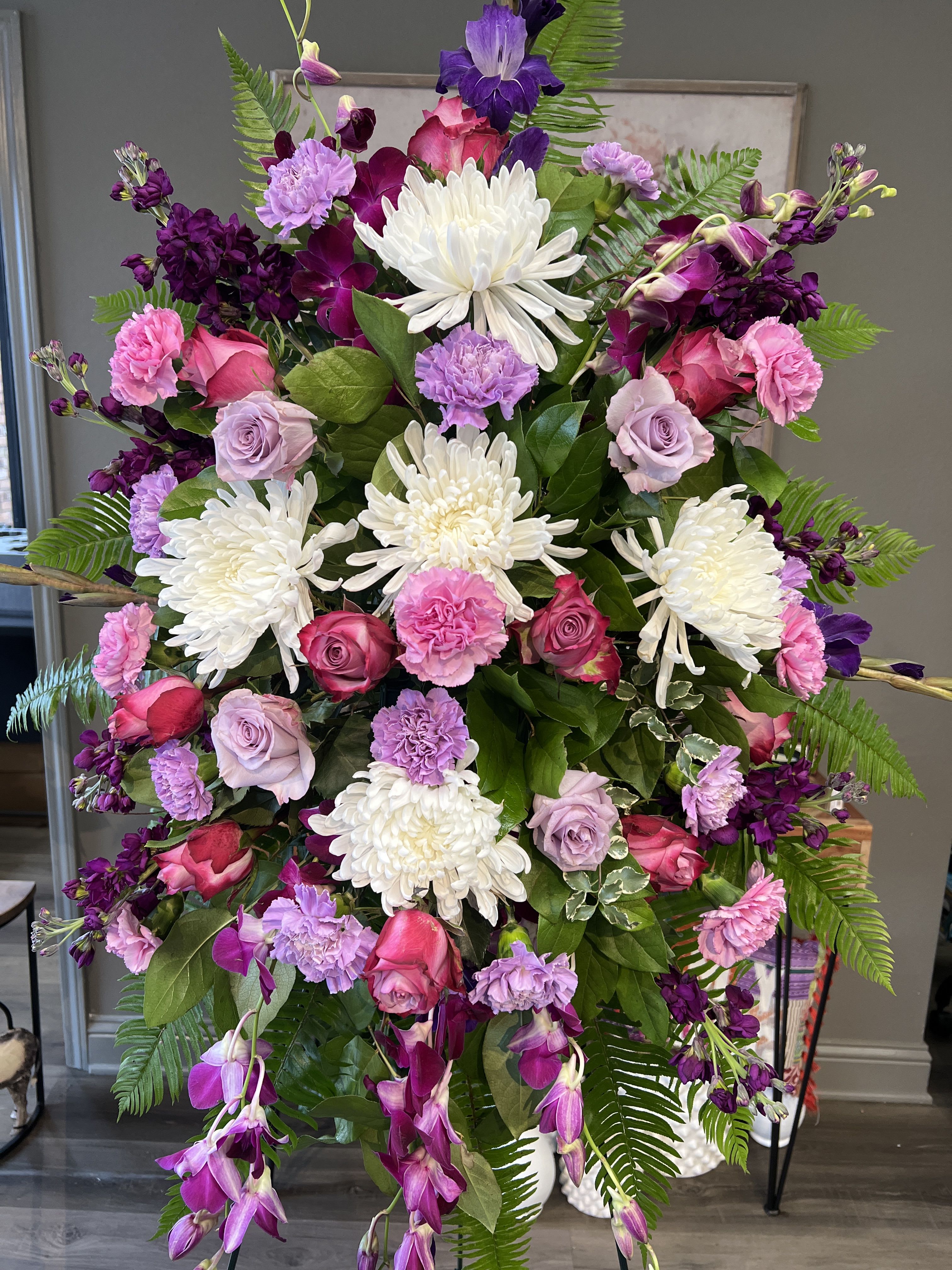 Tall floral spray with white chrysanthemums, pink roses, and purple blooms