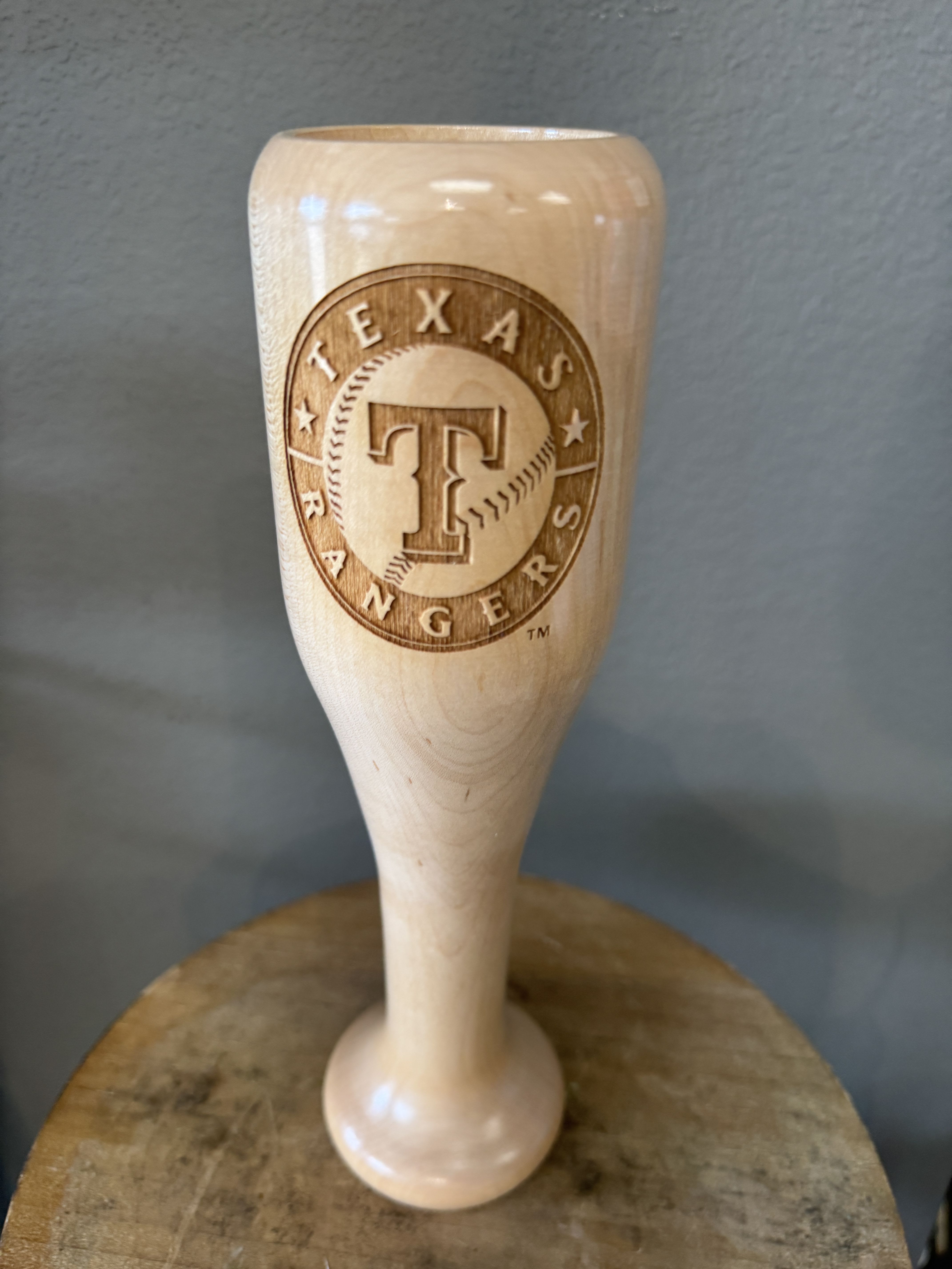 Texas Rangers wooden baseball bat-shaped trophy on a stand