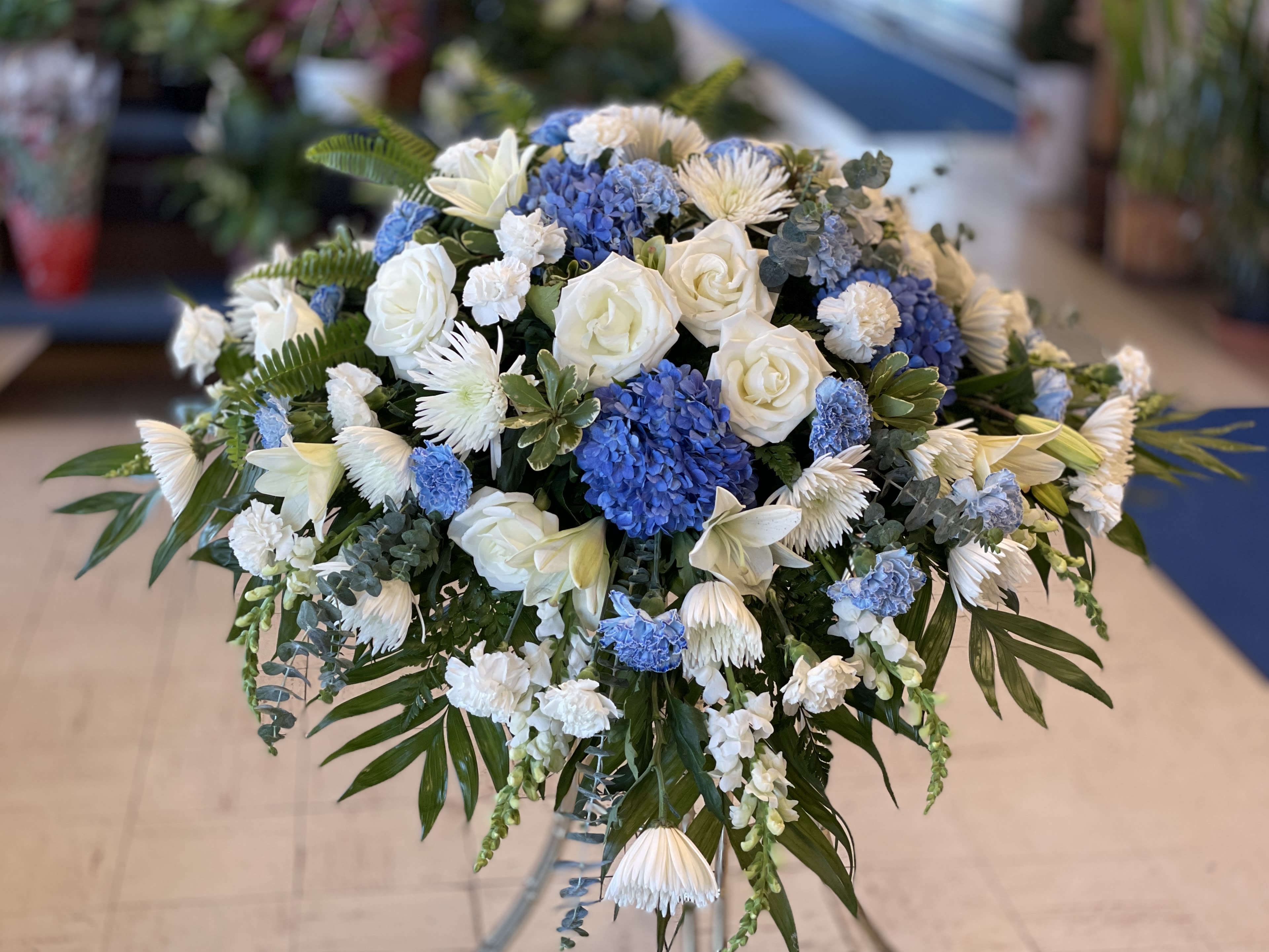 Blue and white floral arrangement in a clear vase