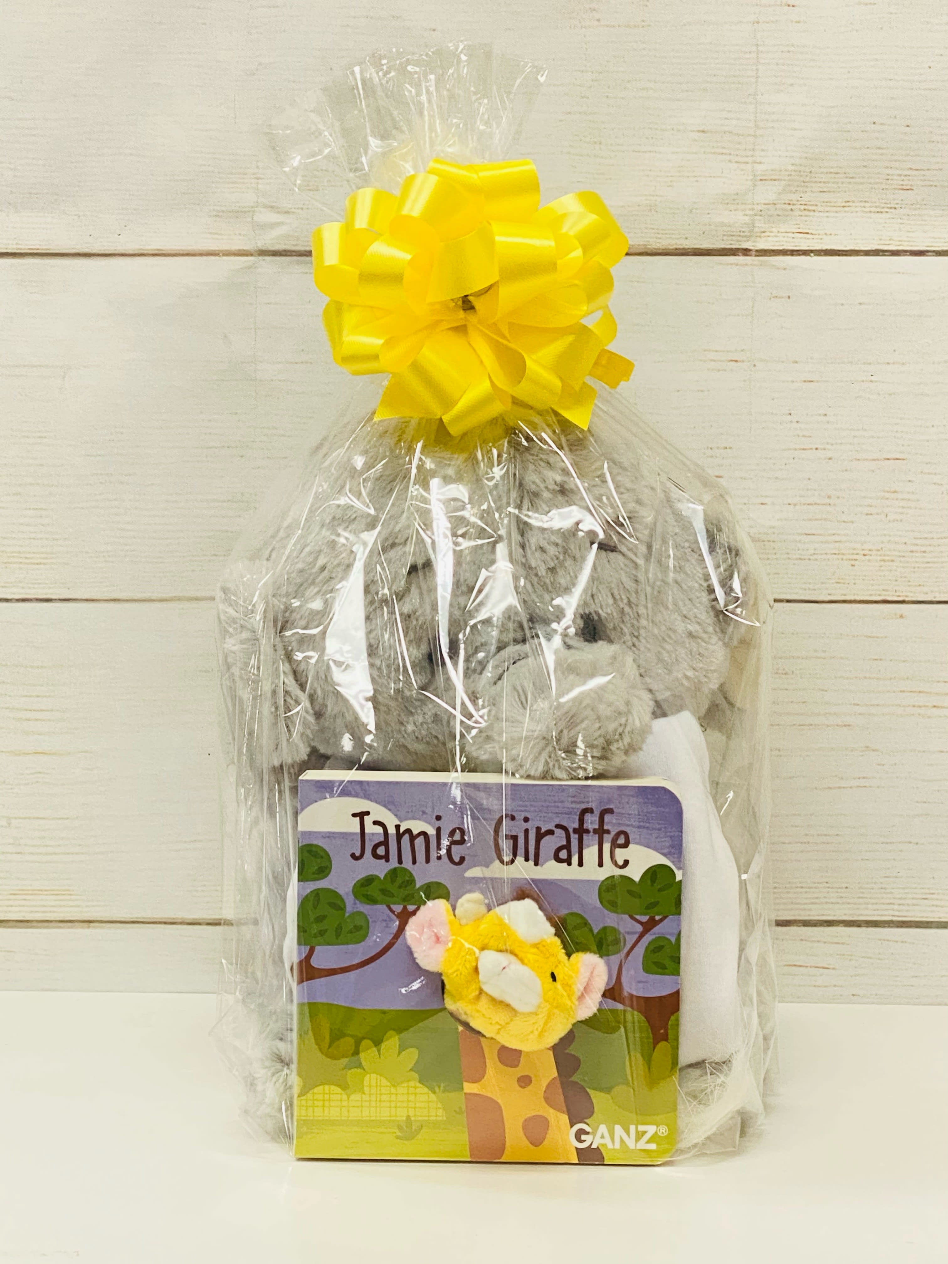 Cellophane-wrapped gift set with gray plush toy and 'Jamie Giraffe' book topped with a yellow bow