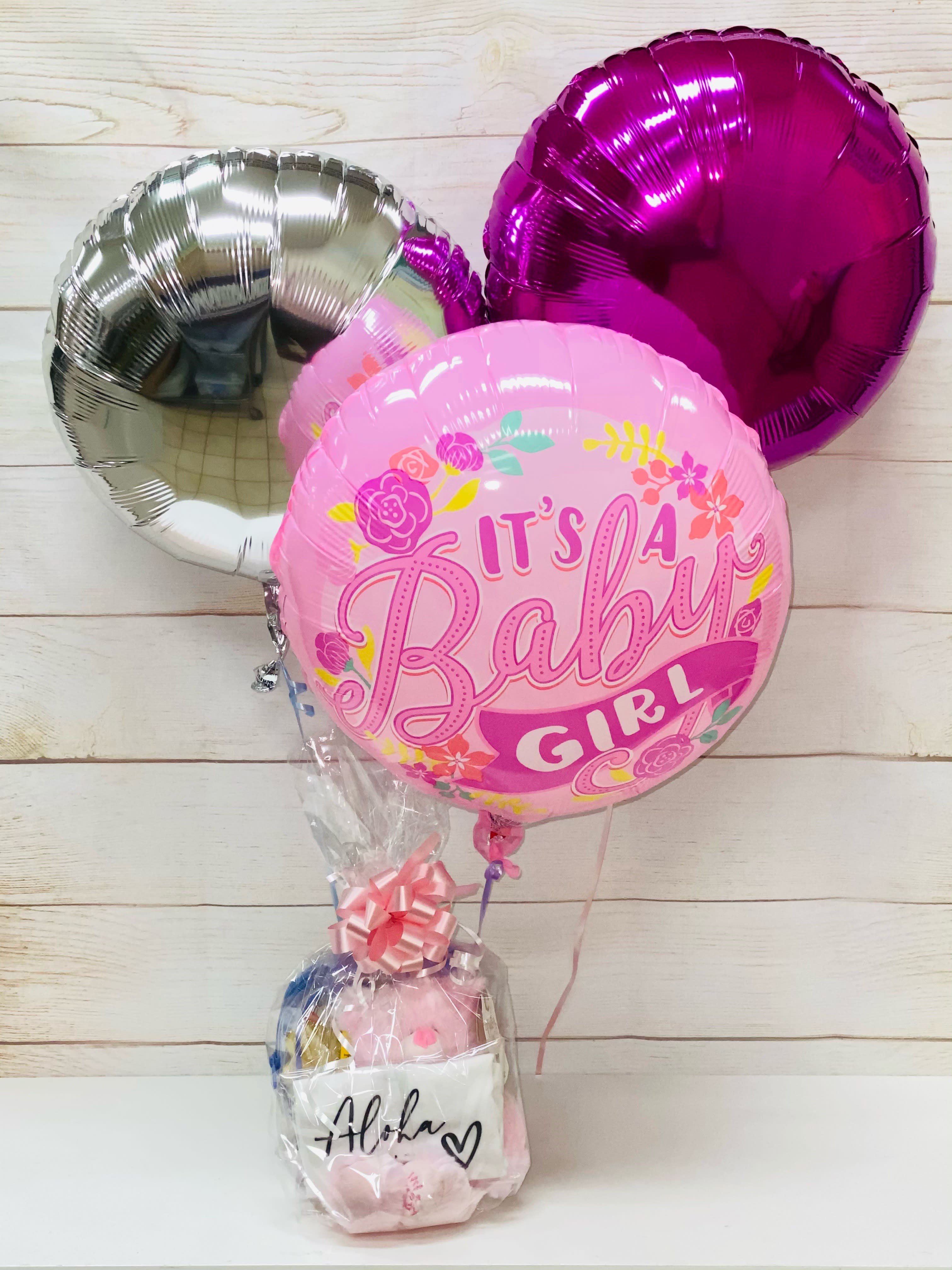 Baby girl balloon bouquet with pink gift basket wrapped in cellophane