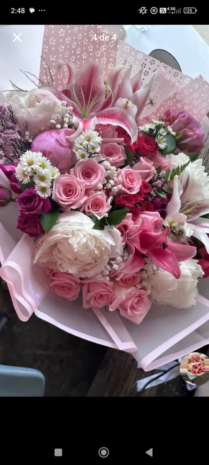 Pink and white bouquet with roses, lilies, and peonies wrapped in pastel paper
