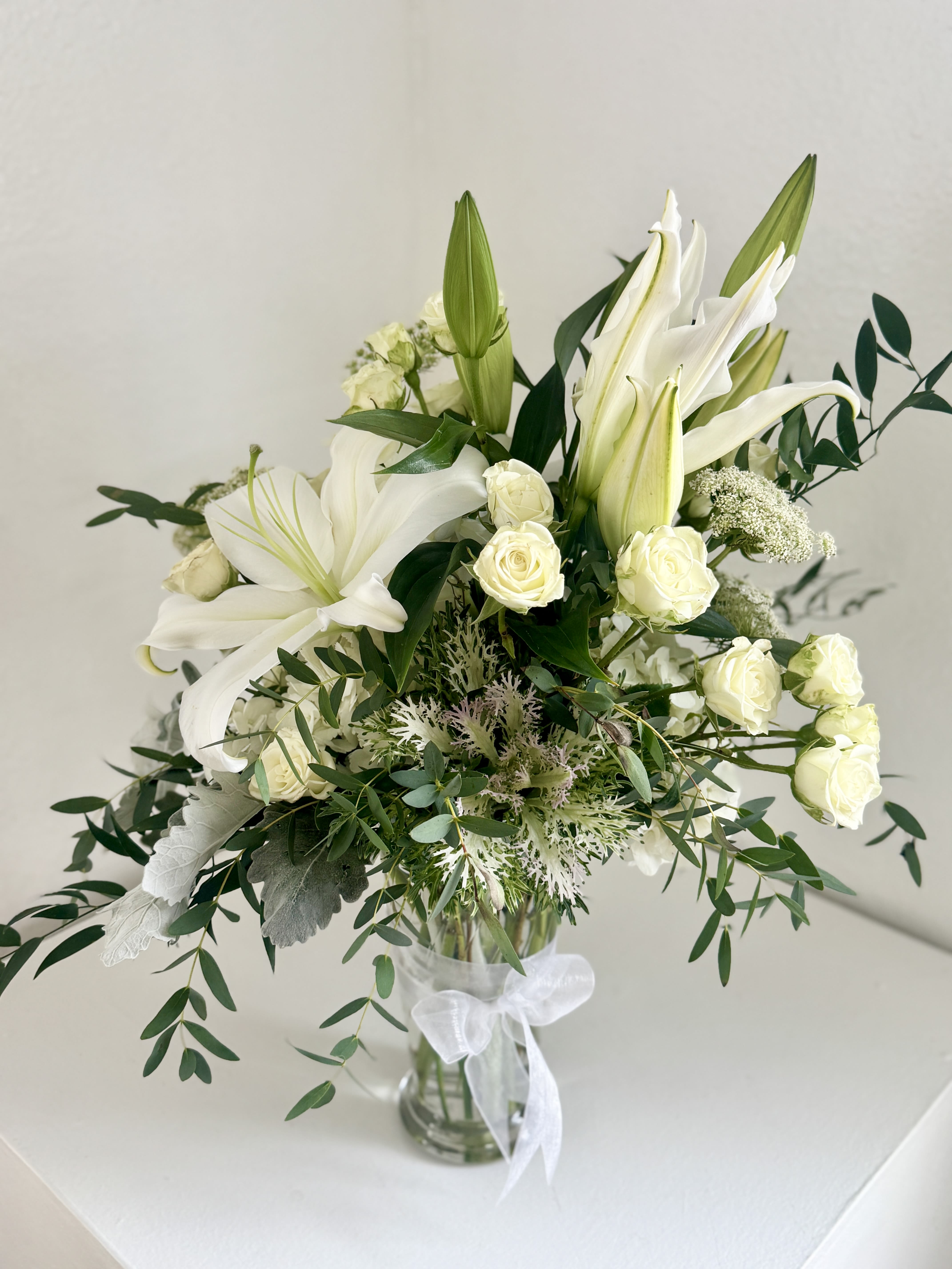 Lily &amp; Laurel - A bouquet that's both graceful and noble. Perfect for celebrating life's meaningful moments, offering comfort, or simple brining refined elegance into any space. 