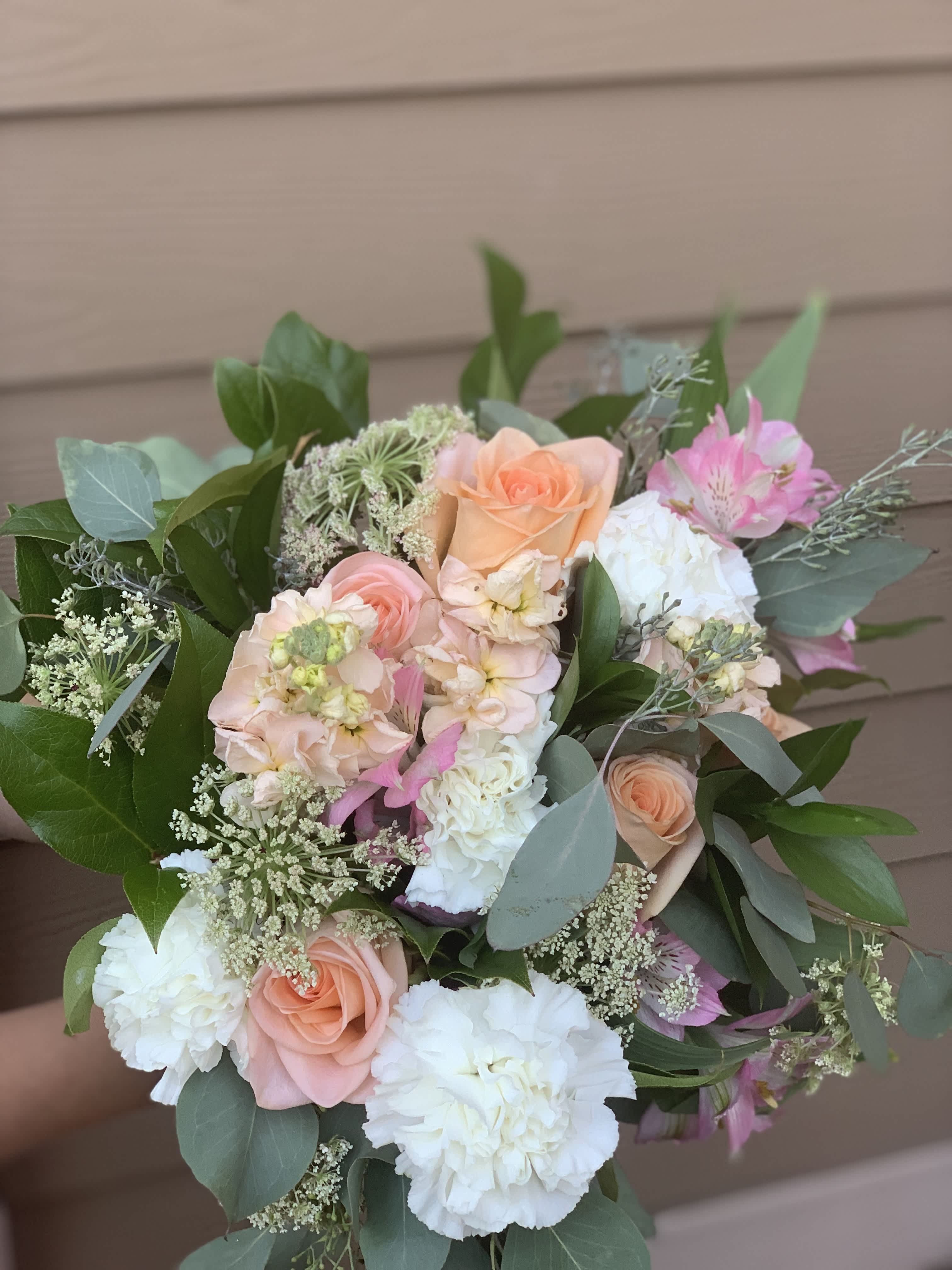 Bouquet of peach, pink, and white flowers with greenery
