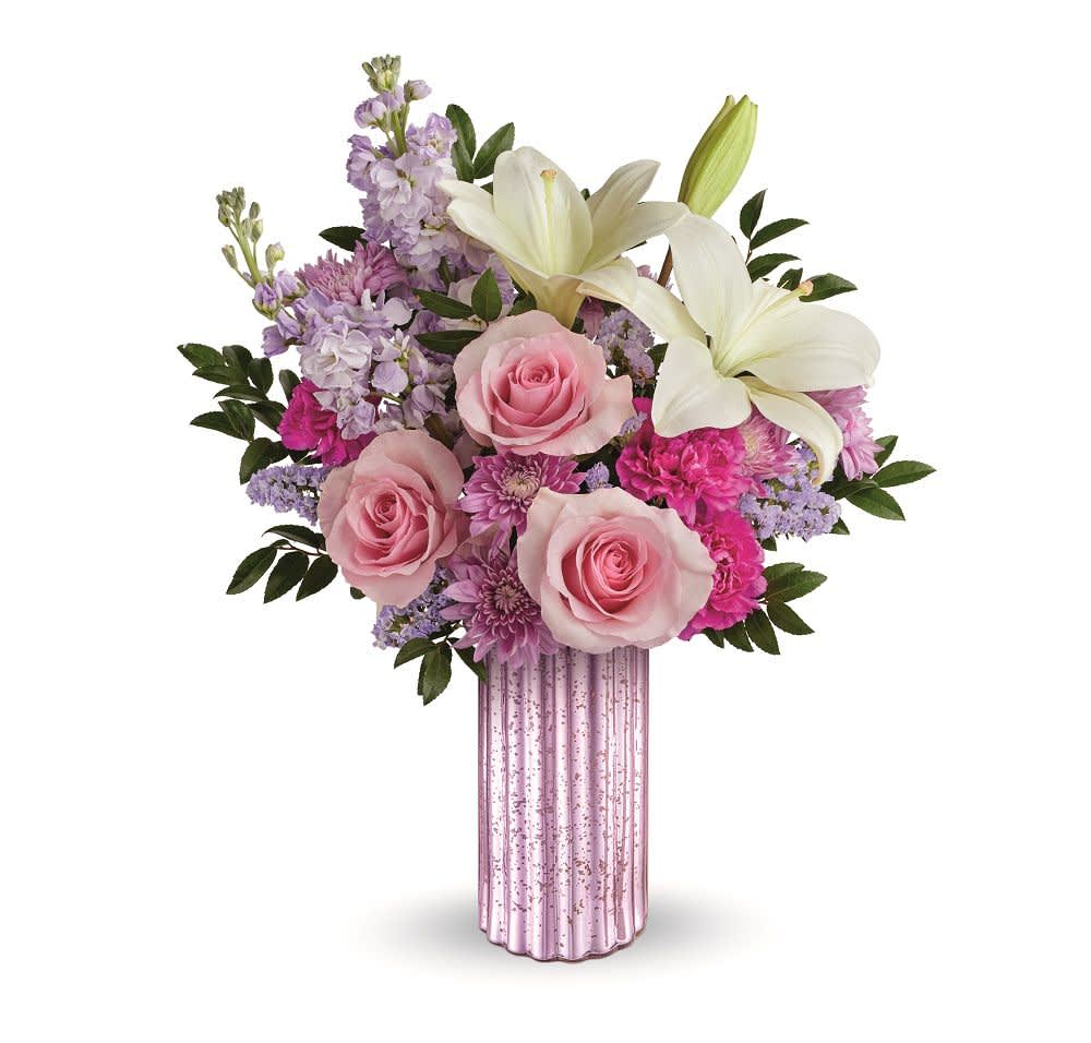Pink roses and white lilies in a pink glass vase