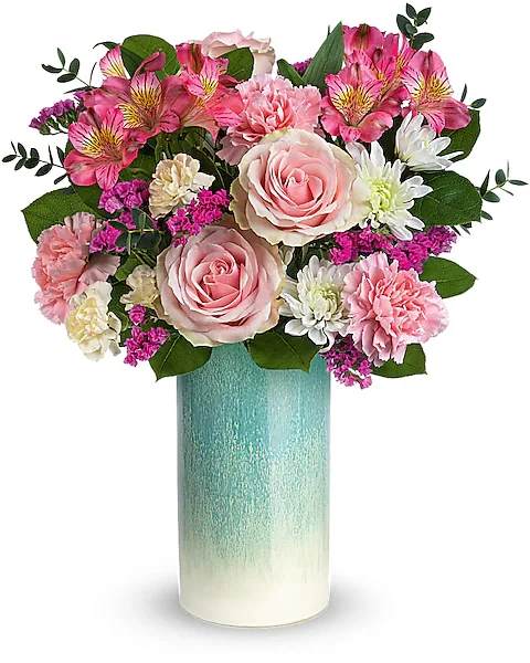 Pink and white flower arrangement in a tall turquoise vase